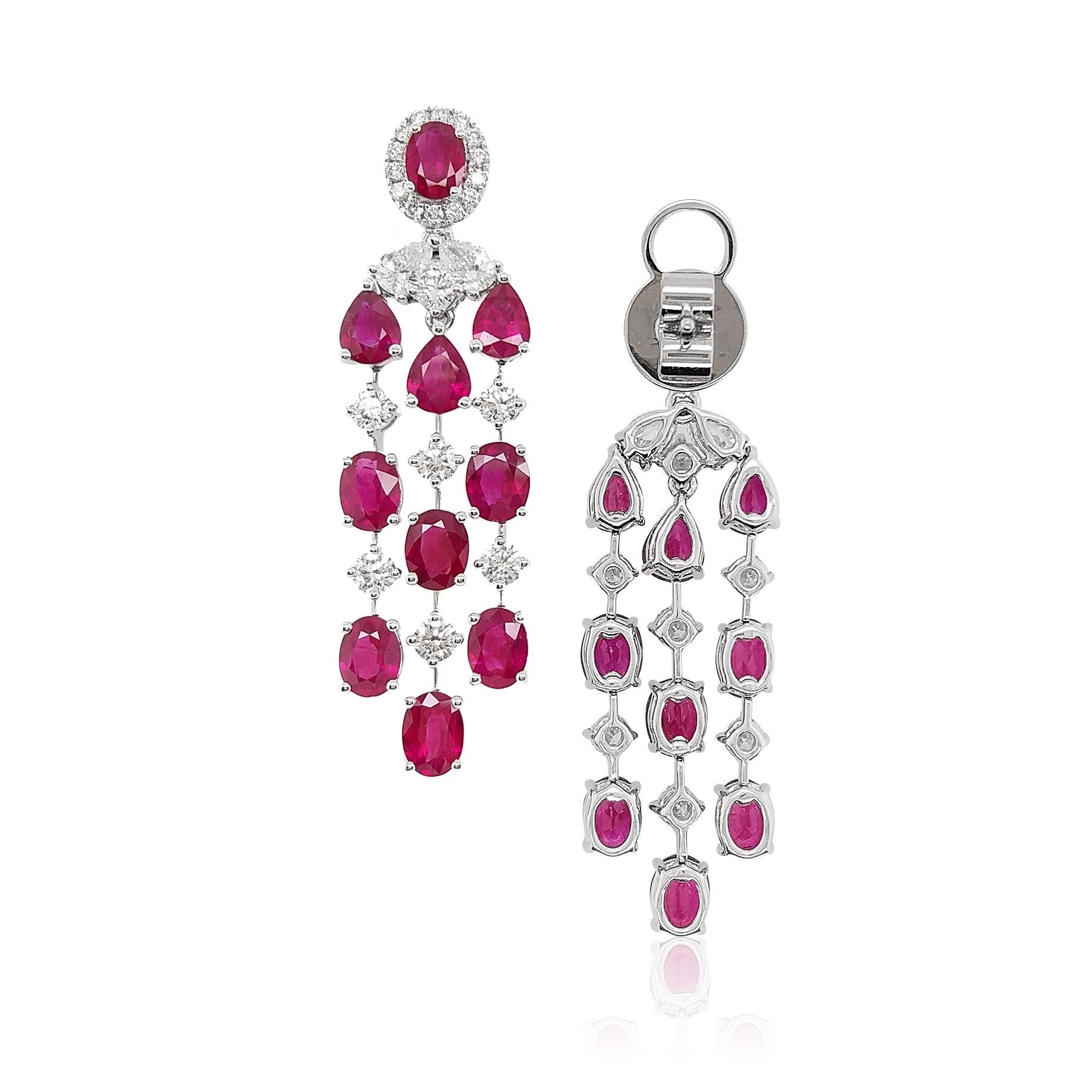 These striking earrings feature lustrous blood-red Burmese Rubies. The unique hue of the rubies is perfectly accentuated by the color of the scintillating White Diamonds from which they hang.
-	Oval shape and Pear shape Burmese Rubies total 6.36