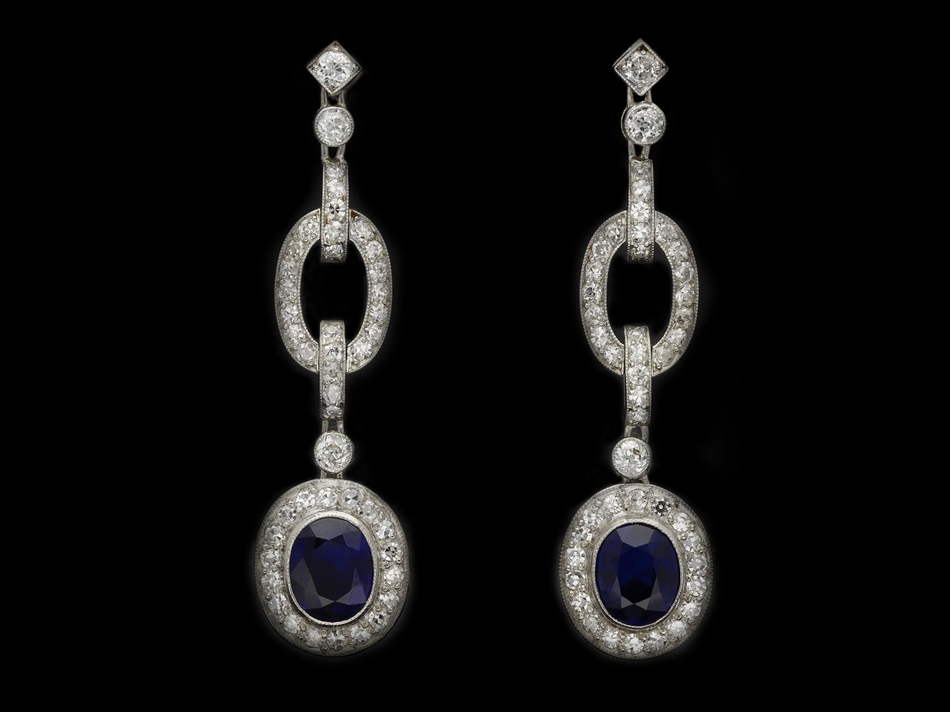 Burmese sapphire and diamond drop earrings. A matching pair of earrings, each set with a cushion shape old cut natural unenhanced Burmese sapphire in an open back rubover setting, two in total with a combined approximate weight of 2.80 carats,