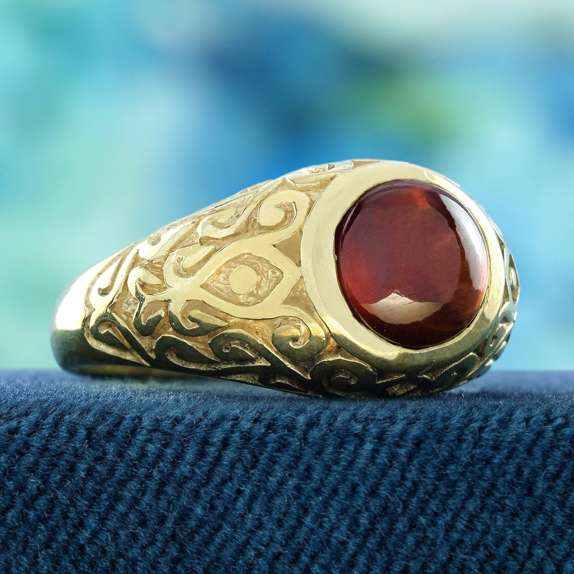 Introducing the stunning Natural Cabochon Garnet Vintage Style Carved Ring in 9K Yellow Gold. This exquisite piece features a rich, deep garnet gemstone, carefully set in luxurious 9K yellow gold. The dome shape and intricate carvings on the band