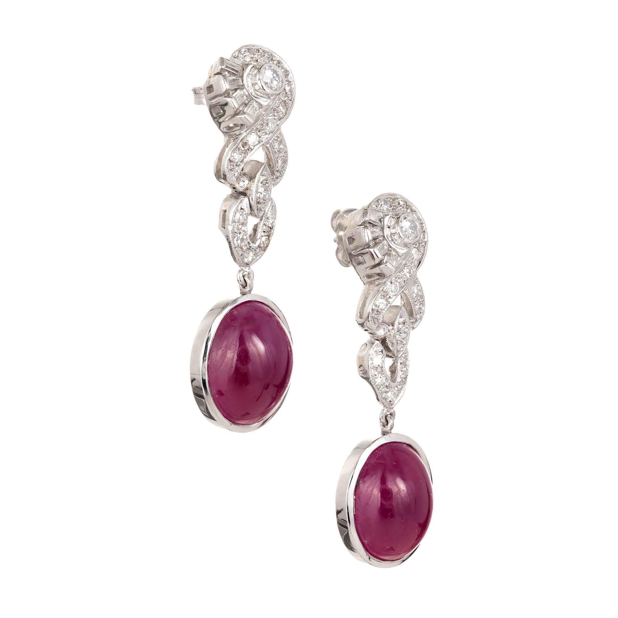 Oval Natural cabochon fine translucent red Ruby 14.32ct and diamond solid Platinum 1940s diamond dangle earrings.

2 natural no heat CMT Type 1, approx. total weight 14.32cts, 11.5 x 6.2mm, true red cabochon Rubies. GIA certificate#1152085780
2 full