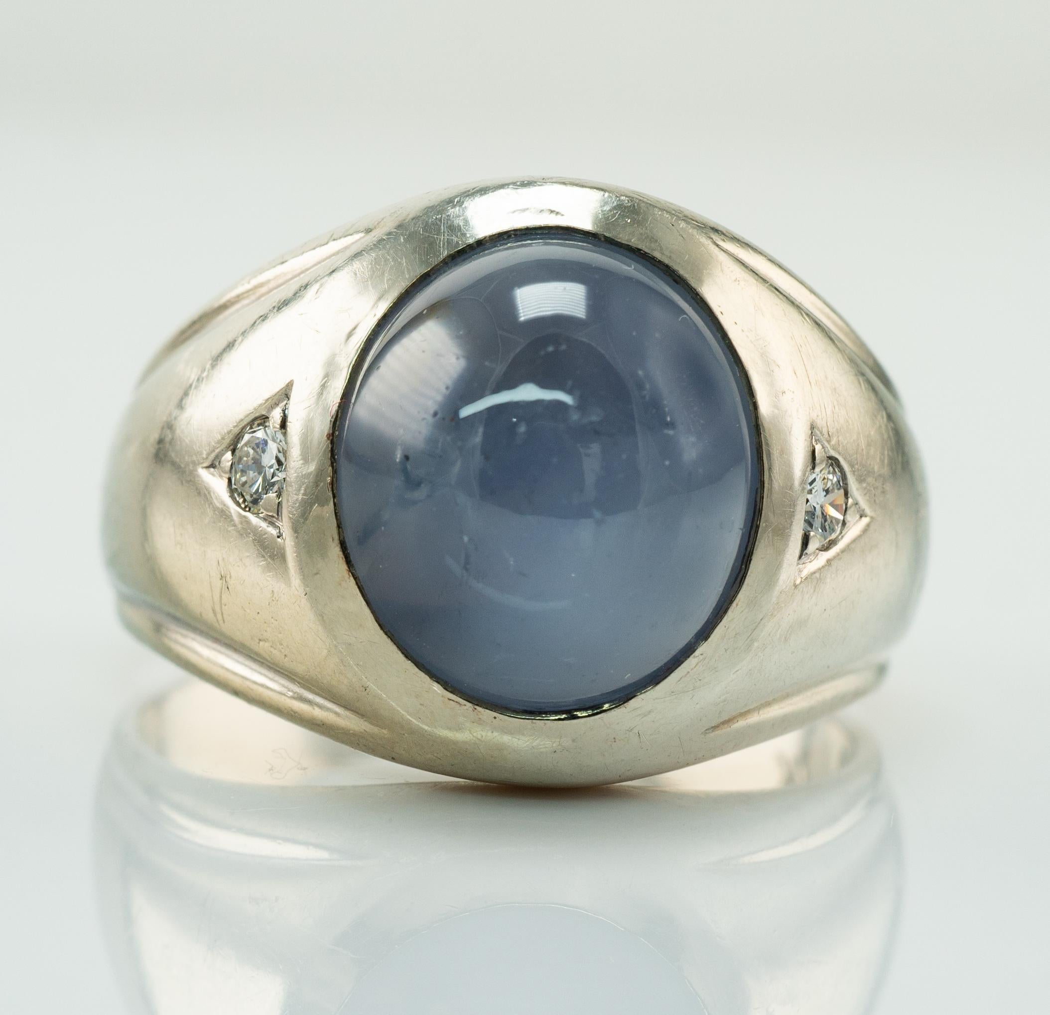 Natural Cabochon Star Sapphire Diamond Ring 14K White Gold

    This vintage ring is crafted in solid 14K White Gold.

    The center natural Earth mined Sapphire cabochon measures 12mm x 10mm (about 6.00 carats).

    The gem has minor signs of