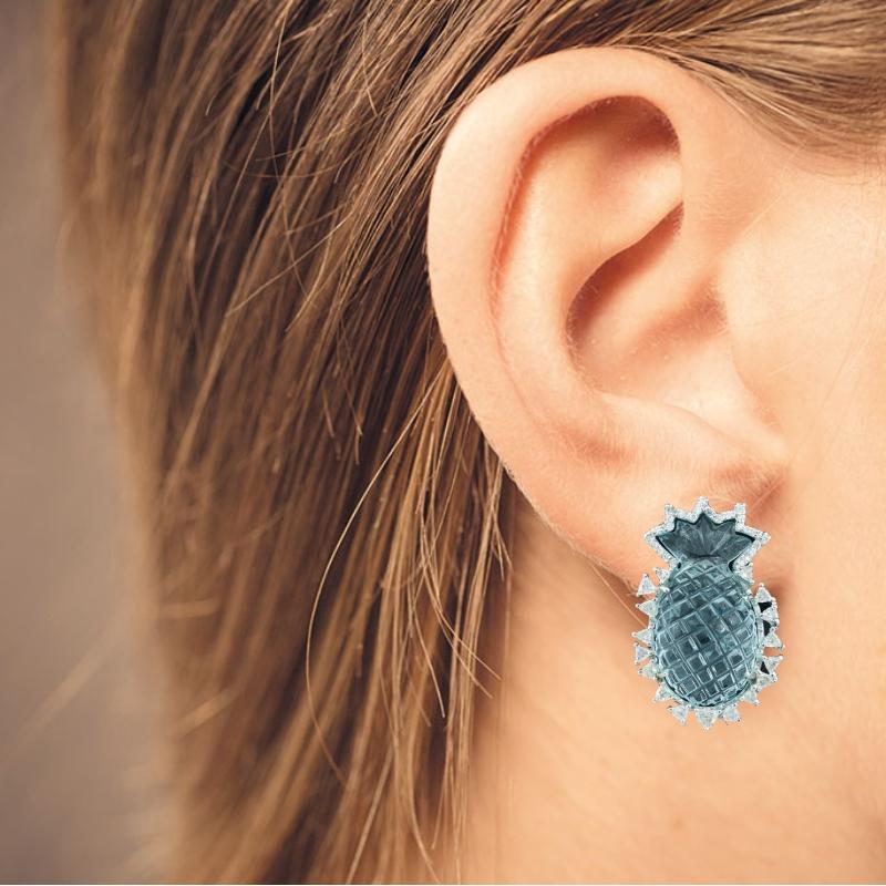 Natural pineapple - carved Aquamarine studs with trillion Rosecut diamonds set in 18K white gold with a clip and easy push - pull back mechanism. The weight of the carved aquamarine pineapple is 43.68cts and diamond trillions are 1.82cts.