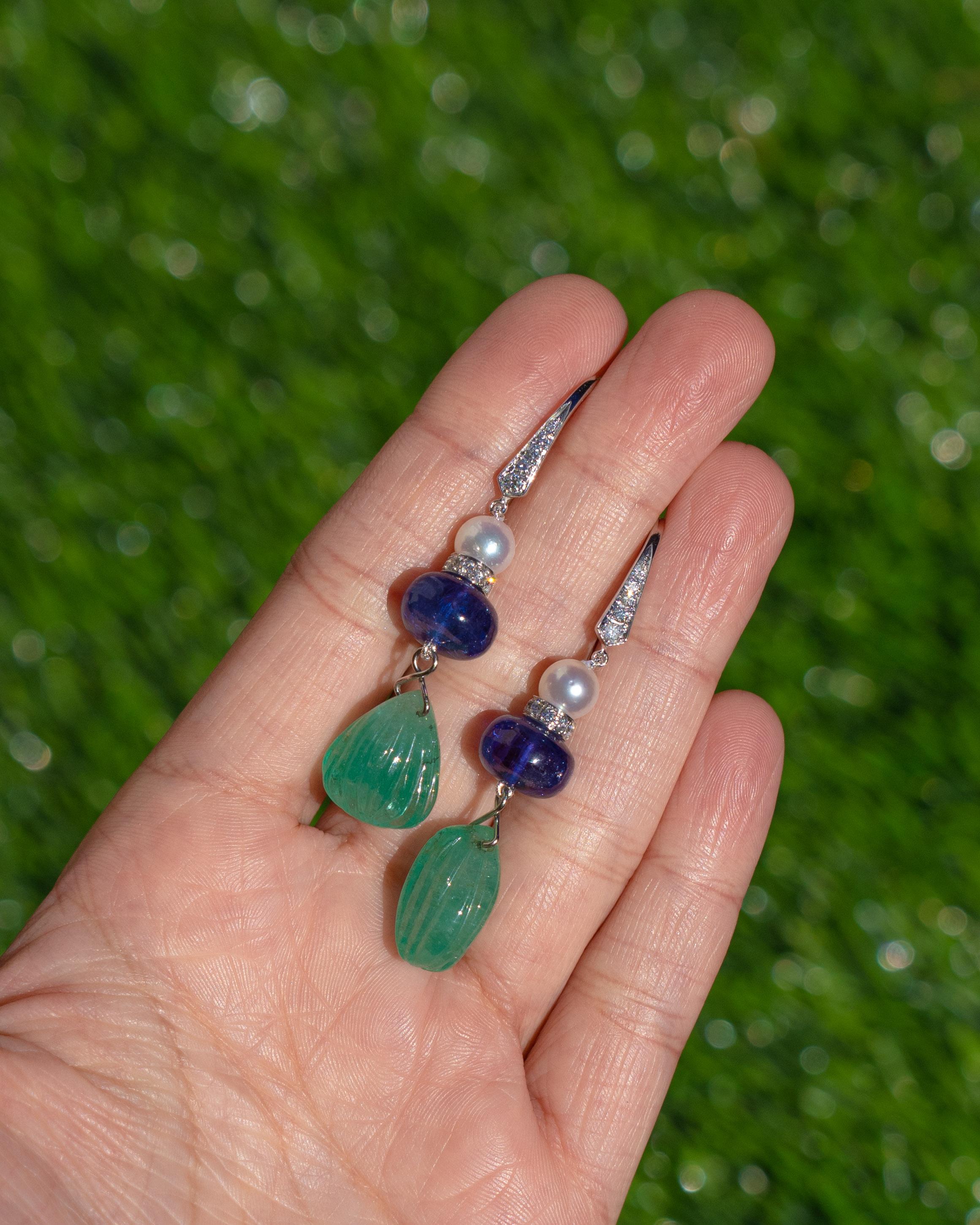 A very beautiful and one of a kind, emerald drop dangle earrings set in 18K White Gold & Diamonds. The weight of the Colombian Emerald Carvings is 25.30 carats. The Emeralds are completely natural, without any treatment and are of Colombian origin.
