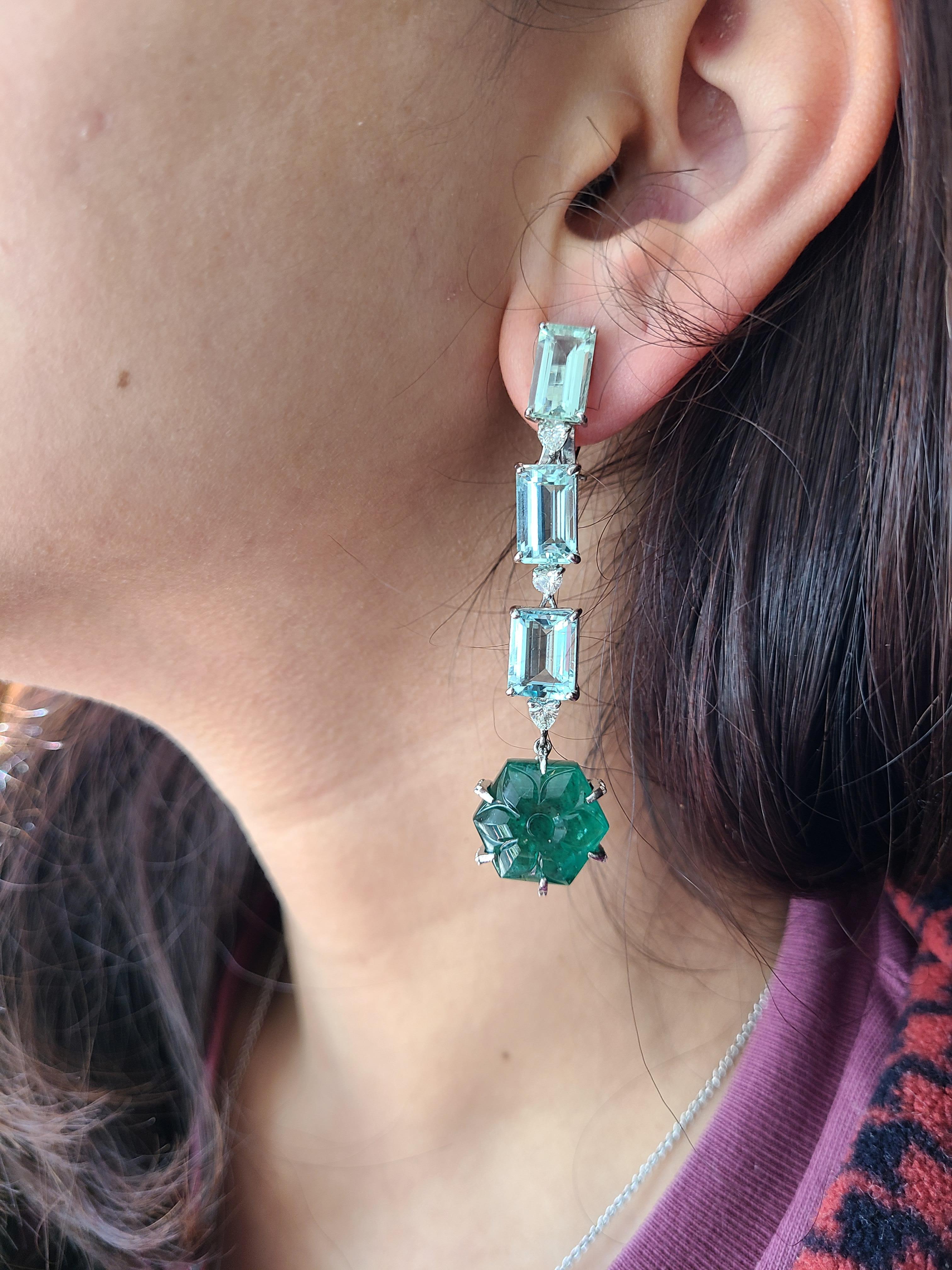 A beautiful long earrings set in 18k white gold with natural emerald, aquamarines and diamonds. The emerald weight is 25 carats , aquamarine weight is 16.17 carats , diamond weight is .81 carats . The net gold weight is 13.095 carats and earrings