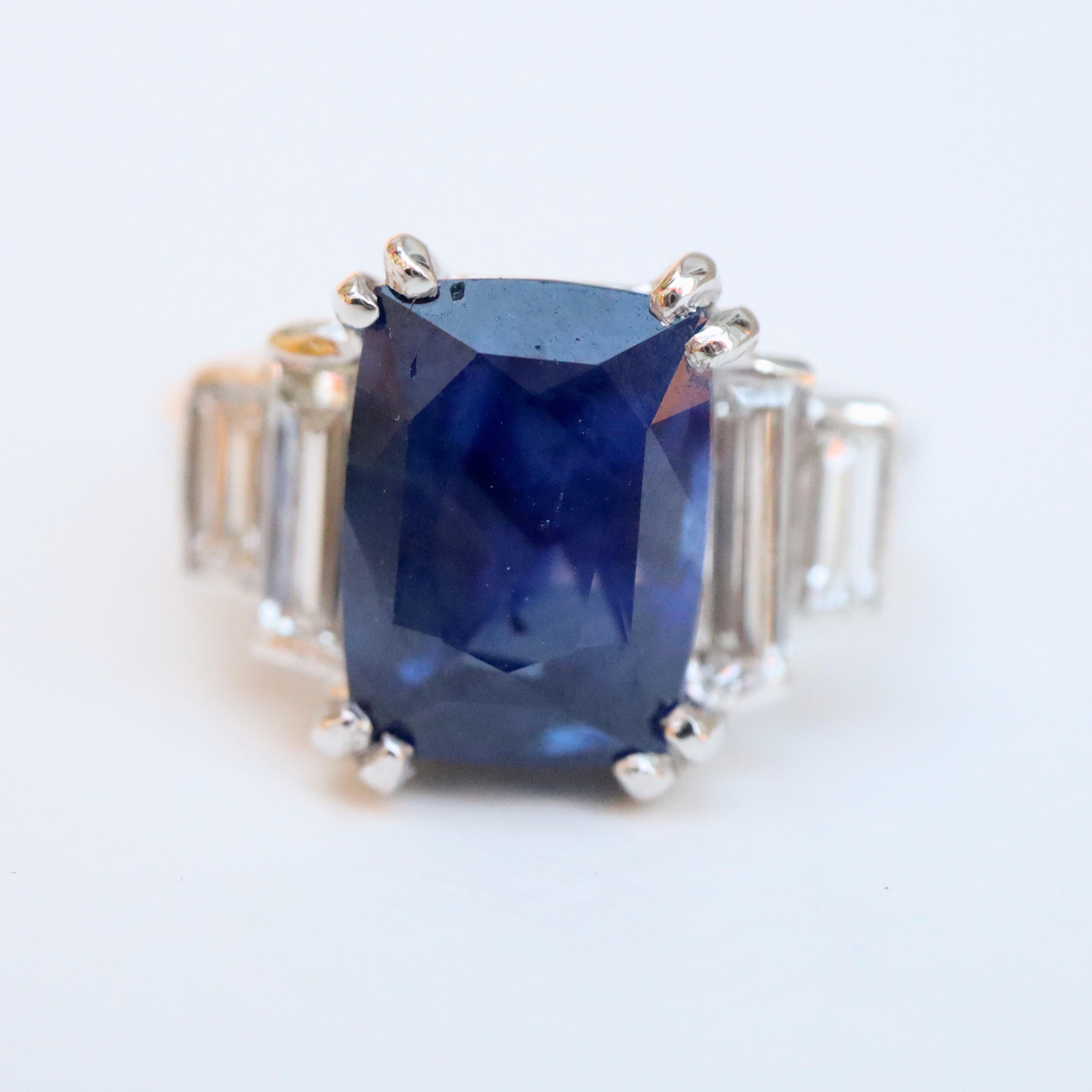 Ceylon Sapphire ring. 18 Carat White Gold Ring set in its Center with a Large Ceylon Sapphire weighing 4.59 Carats set with double Prongs, supported on either side by two Baguette-cut Diamonds approximately 0.15 to 0.2 Carat.
Total Diamond Weight: