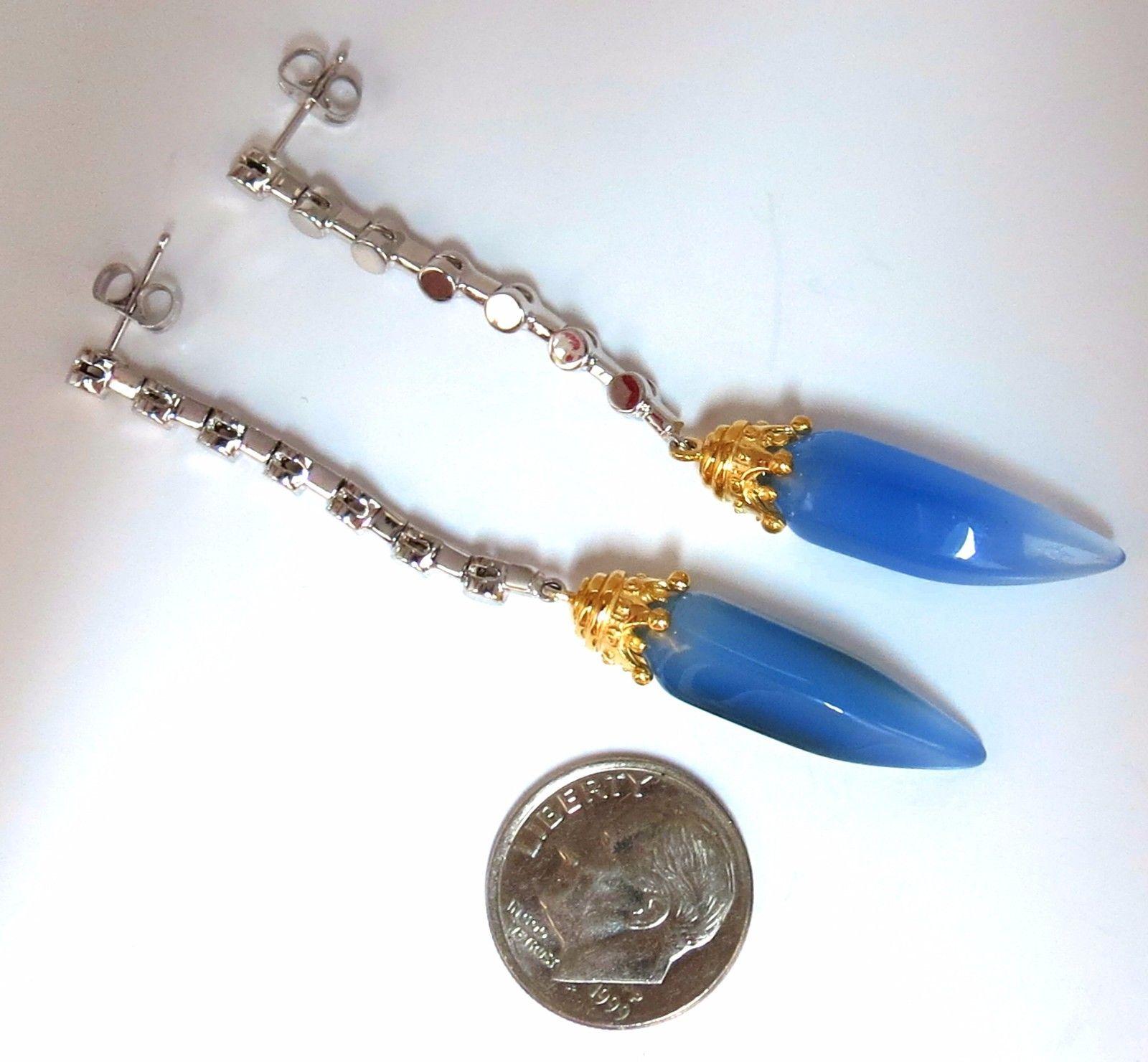 Natural Chalcedony dangle earrings.

Beautiful Match.

24 X 8mm each 

Gorgeous brilliance

Beautiful fade from lilac blue  

Overall measurements:

2.6 Inch long overall.

11 grams.

14kt. white / yellow gold.

Comfortable to wear / butterfly push