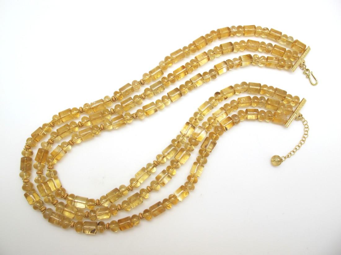 This necklace is so pretty and unusual - and the neutral color goes with everything! It features 3 strands of highly transparent, golden citrine beads of various sizes and shapes, hand-strung with 14k and 18k yellow gold rondelle spacers for extra