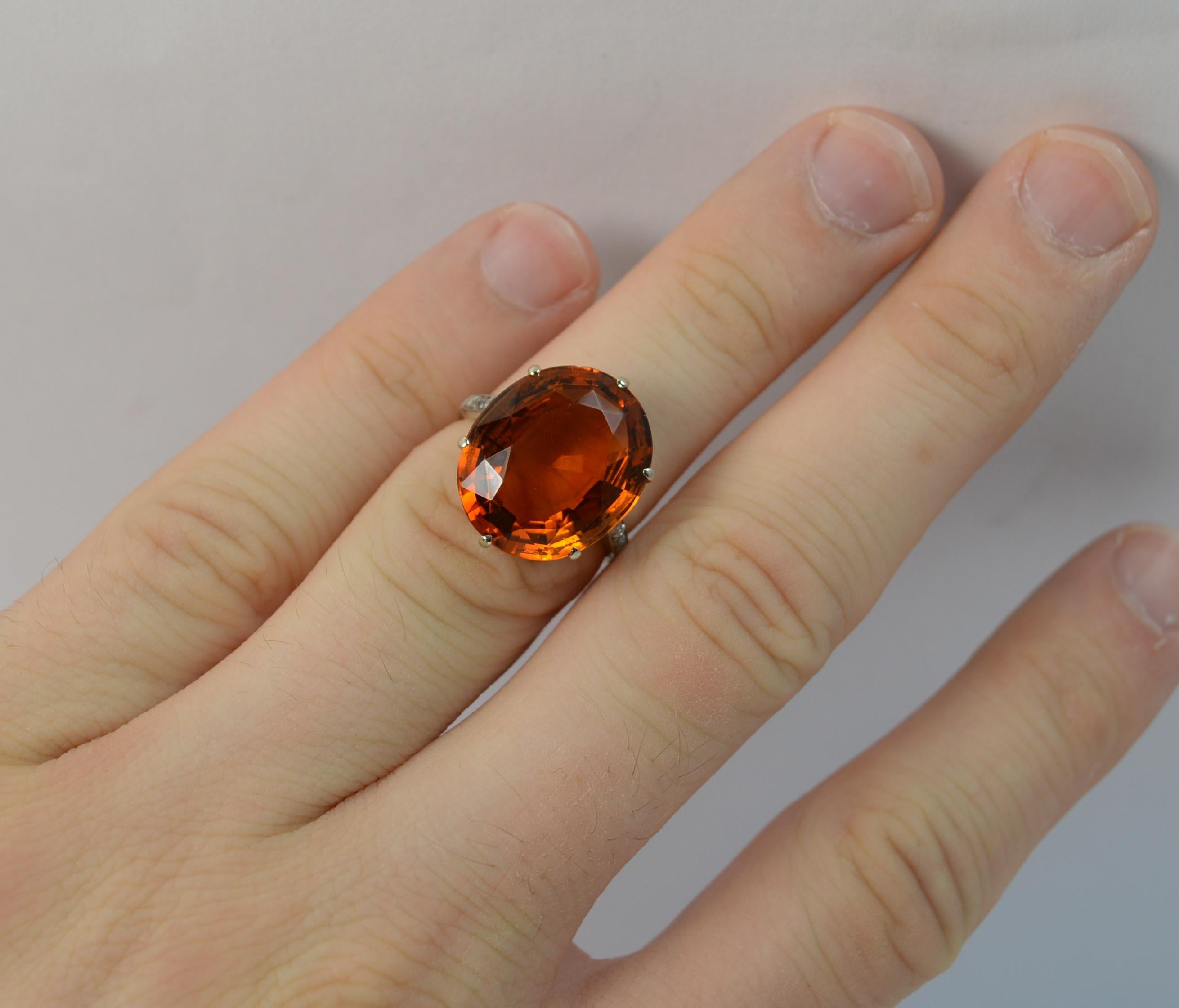 An impressive Citrine statement ring. c1930.
SIZE ; K UK, 5 1/4 US. Can be sized.
Solid 18 carat white gold shank and setting.

Set with a natural citrine of amazing vibrant orange colour and set in six claw setting to measure approx 13.5mm x 16.1mm