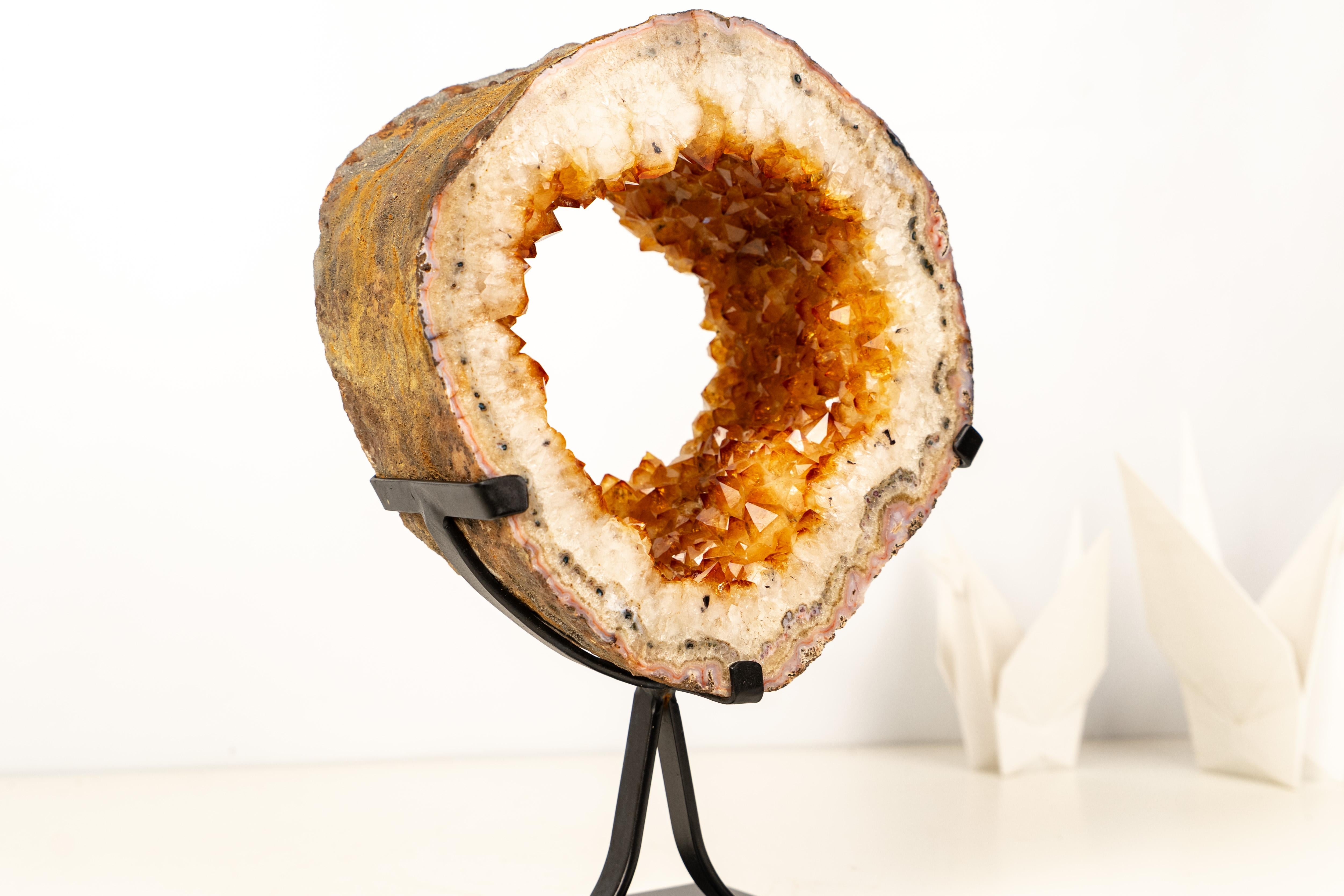 Citrine Geode Portal Slice – Golden Orange Citrine on Stand

��▫️ Description

With striking presence and rare beauty, this Citrine Geode Portal brings beautiful aesthetics and an outstanding natural formation. The golden-orange citrine displays