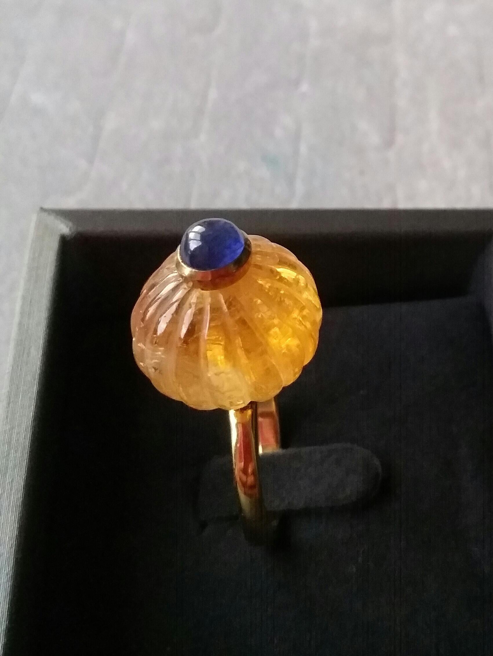 Melon cut Citrine Quartz Round Bead  of 16mm. in diameter and 14 mm. thick with in the center a round blue Sapphire cabochon of 8 mm. in diameter in the  is mounted on top of a 14 Kt. yellow gold shank.
In 1978 our workshop started in Italy to make