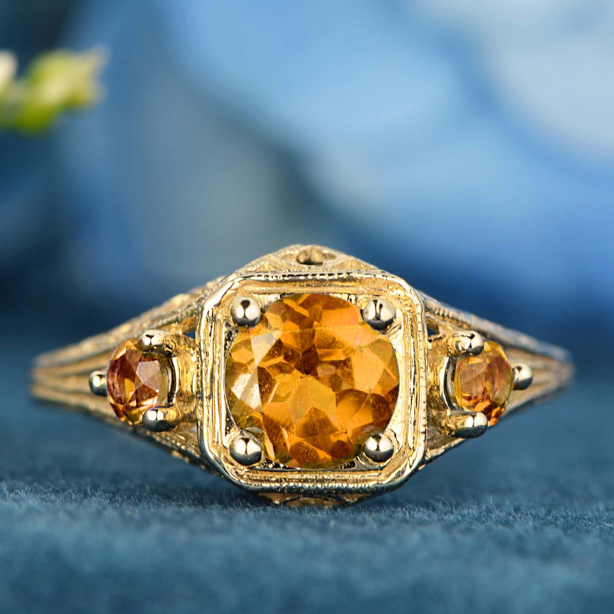Make a bold statement with our Natural Citrine Vintage-Style Filigree Three Stone Ring in Solid 9K Yellow Gold. 
This striking ring features a brilliant natural citrine at its center, radiating a warm golden glow that captures the light beautifully.