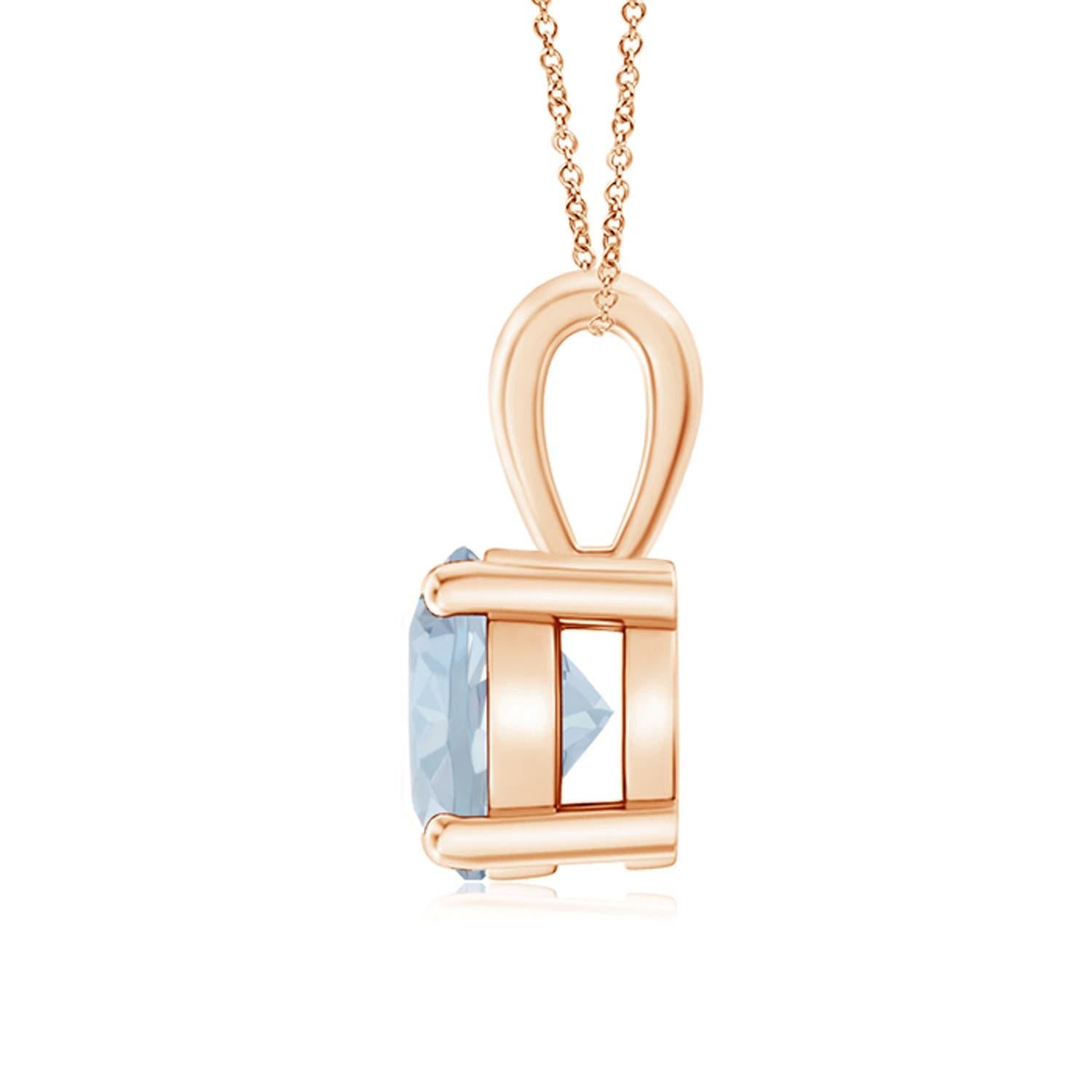 Un solitaire d'aigue-marine bleu marine, serti dans une monture à quatre griffes, est relié à une balle lustrée. Réalisé en or rose 14 carats, le design élégant de ce pendentif classique en aigue-marine attire toute l'attention sur la magnificence