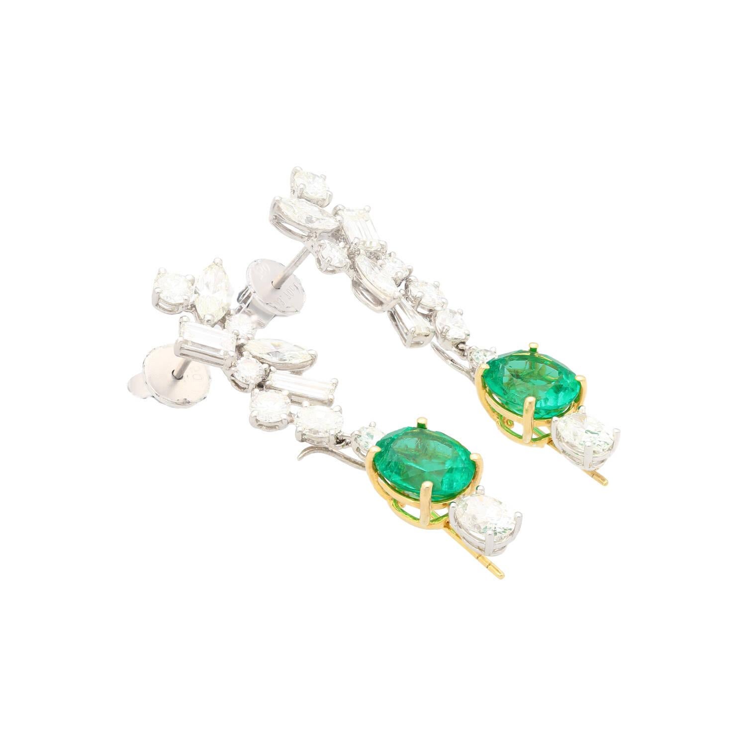 18K Yellow and White Gold detachable drop earrings. Featuring a symphony of natural emeralds and diamonds. Set with two Oval Cut Colombian Emeralds, weighing 2.37 and 2.29 carats and originating from Colombia. One of which is GRS certified