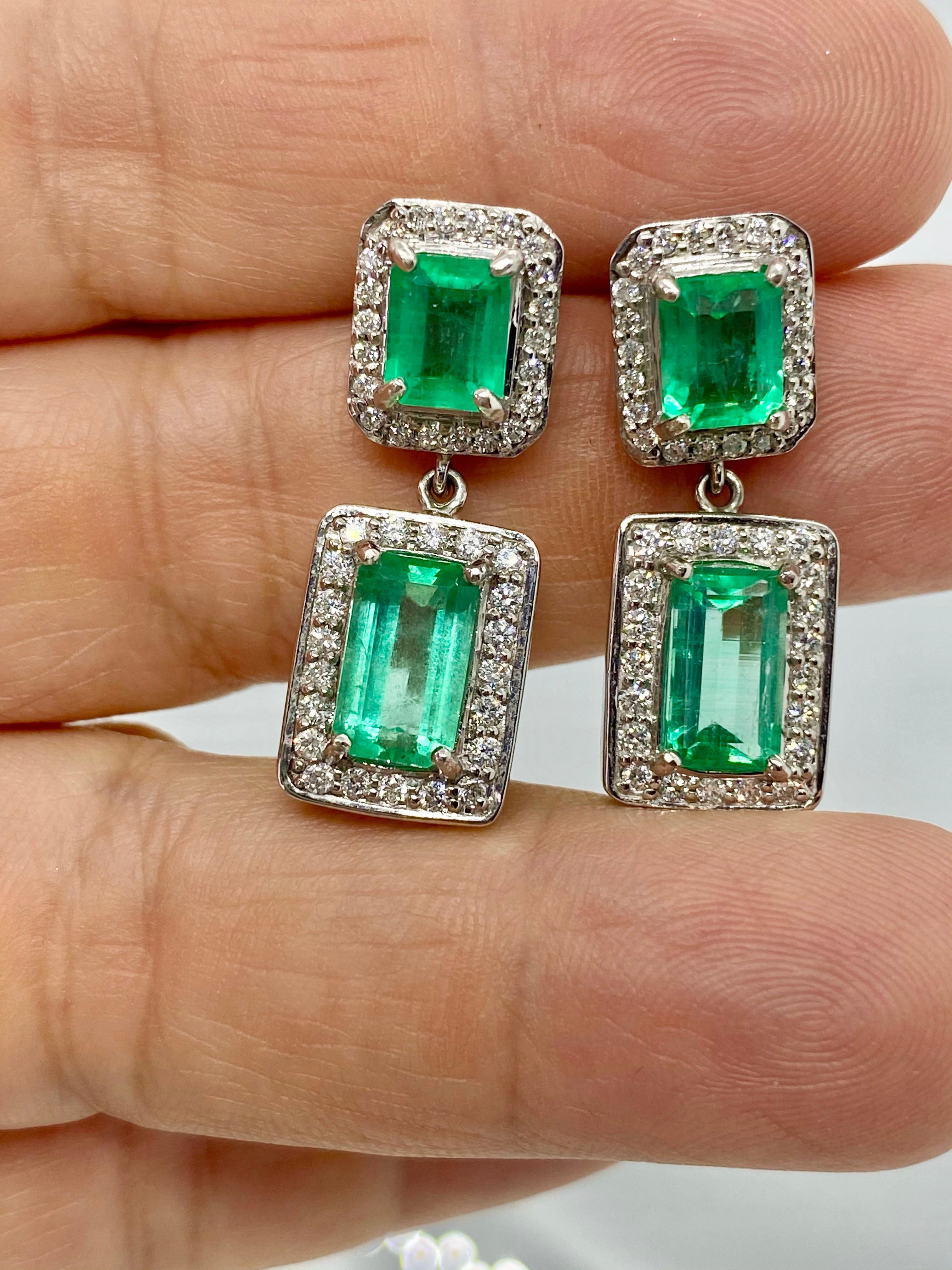 Elegant Natural Colombian Emerald and Diamond Drop Dangle Earrings 18K White Gold 
Primary Stones: 100% Natural Colombian Emerald 
Shape or Cut Emerald: Emerald Cut   
Color/Clarity: Brilliant Medium 100% NATURAL Green Color/ Clarity VS 
Total