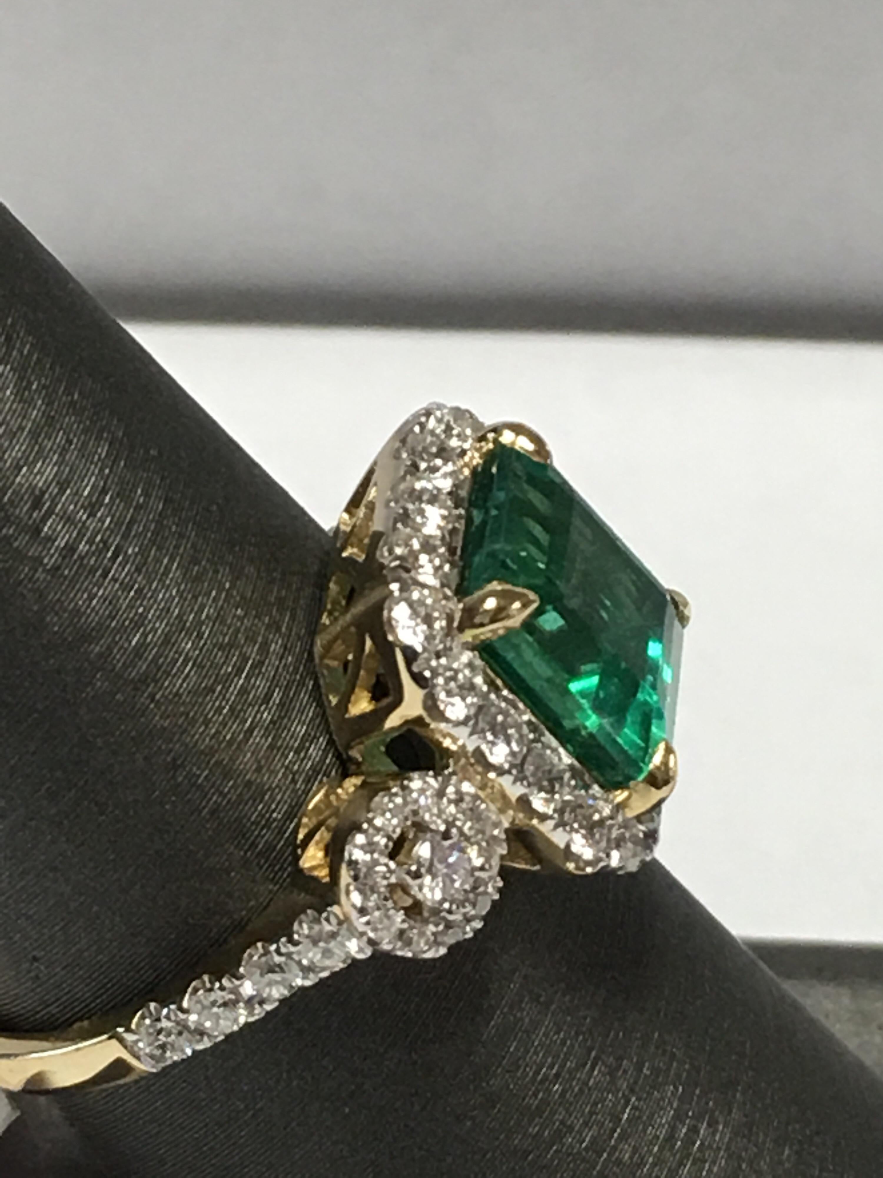 Emerald and diamonds ring set in 14K Yellow gold .Emerald weigh 3.15CTS and 0.78 CTS White round diamonds E color VVS 2 diamonds. Ring size is 7