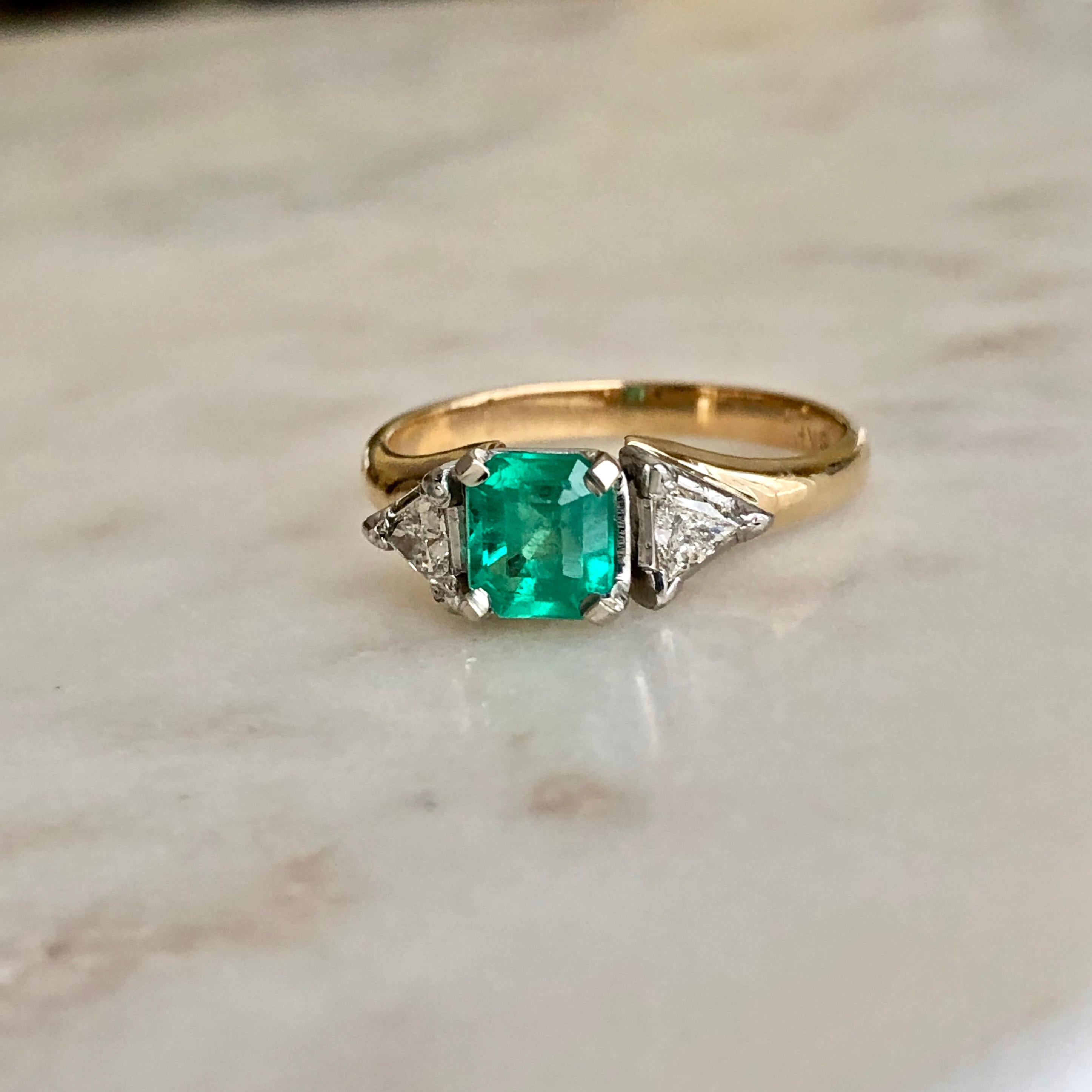 Classic engagement ring that is centered with an natural square-cut emerald from Colombia with 'nice medium green’ color, weighing 0.78ct and two genuine triangular brilliant-cut diamonds weighing 0.26ct H-VS-SI1. Total ring weight 4.6g made of