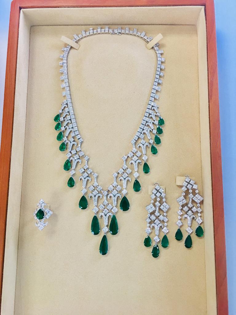 Stunning Looking Natural all Matching beautiful color Colombian Pear Shape Emerald and Diamond Set. Certified Set includes a matching Necklace with 17 Emeralds, a pair of ear pendants with 6 Emeralds., and a ring set with 1 Emerald.

Emeralds