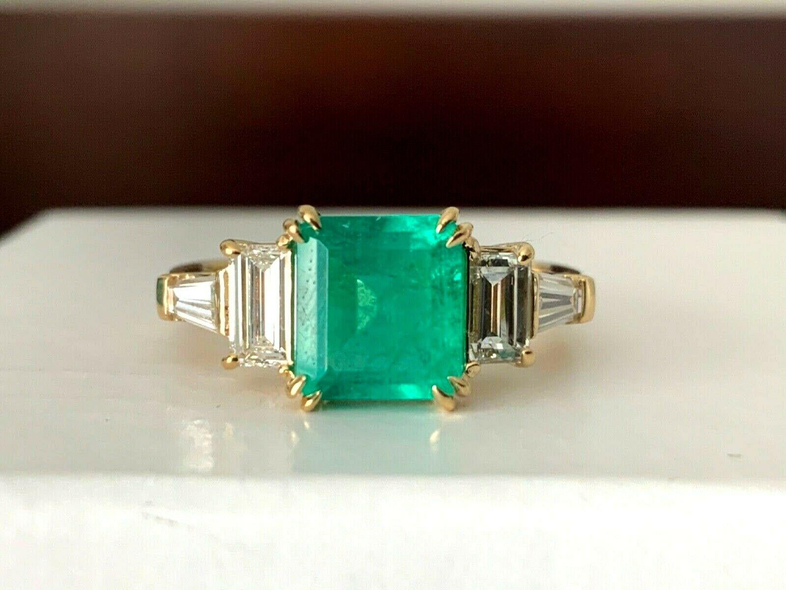 For your consideration is a 1.40 carat Octagonal step cut , natural, semi-transparent, green emerald set in a brand new 18k white gold setting with ..83 carats of natural G color VS clarity white diamonds.  The natural emerald is GIA certified and