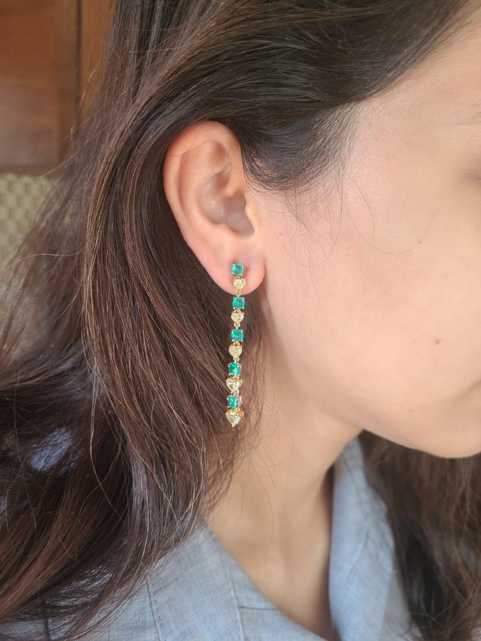 A pair of very beautiful and dainty Emerald Chandelier Earrings set in 18K Gold & Diamonds. The weight of the Emeralds sugarloafs is 3.75 carats. The Emeralds are of Columbian origin and are completely natural, without any treatment. The weight of