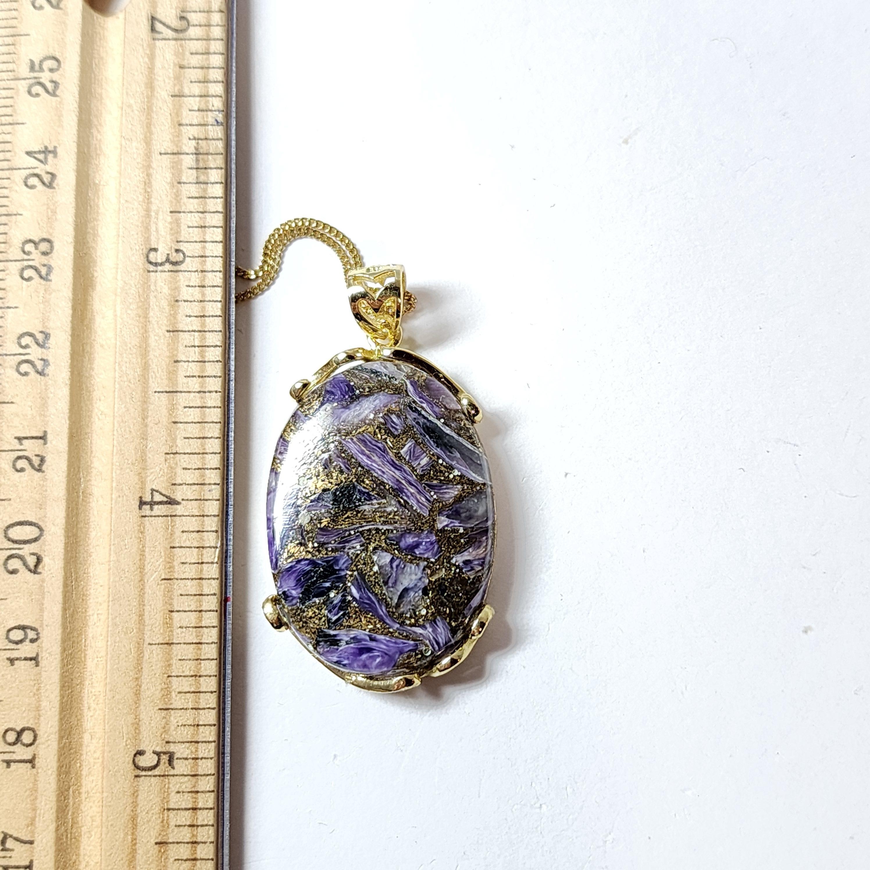 Natural Copper Malachite Pendant 

Features beautiful deep purple flash 
Unique keystone Oval shape.
Large and in charge, our upsized copper malachite necklace features a big oval stone with one-of-a-kind natural inclusions, a classic gold vermeil 