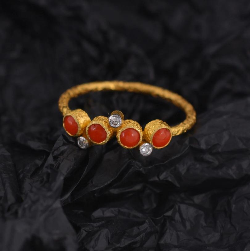 Adorable yet sophisticated, fancy yet subtle, this ring is all you need and more. Set in 18K yellow gold and encrusted with 0.05-carat natural diamonds and 0.03-carat coral gemstones, this piece will make a handsome addition to your
