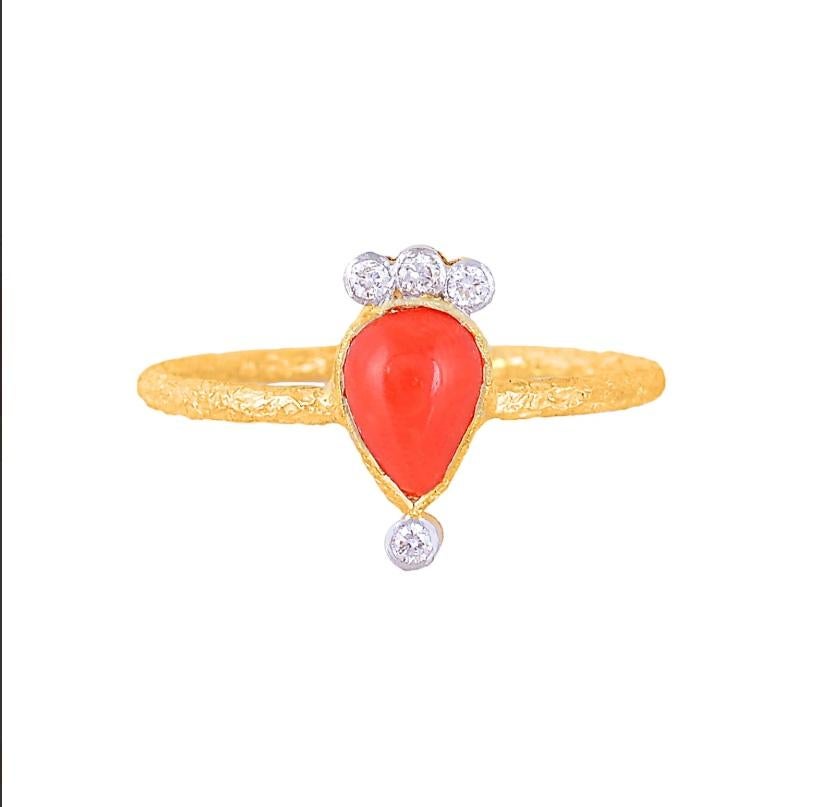 Red and Regal! This Stunning and beautiful coral gemstone ring is made with 18k yellow gold and with 0.07 carat natural diamonds. So accentuate your enchanting aura with this intricate finger ring, with a drop shaped design and embedded diamonds!