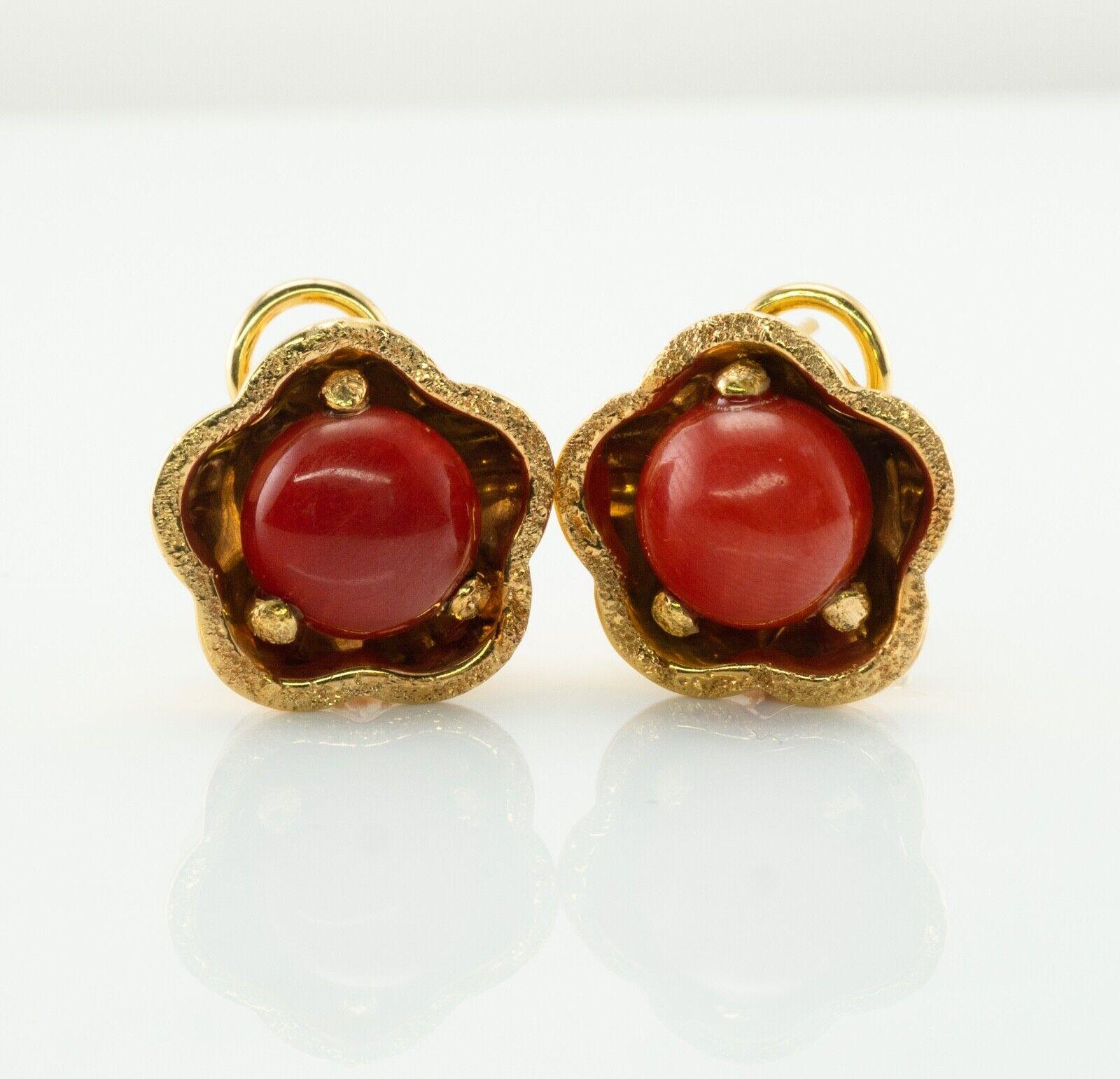 Natural Coral Earrings 18k Gold Italy Omega Backings

This pair of estate earrings is crafted in 18K Yellow gold, made in Italy. Each natural untreated coral cabochon measures 10mm. The setting measures 17mm. The earrings are equipped with a very