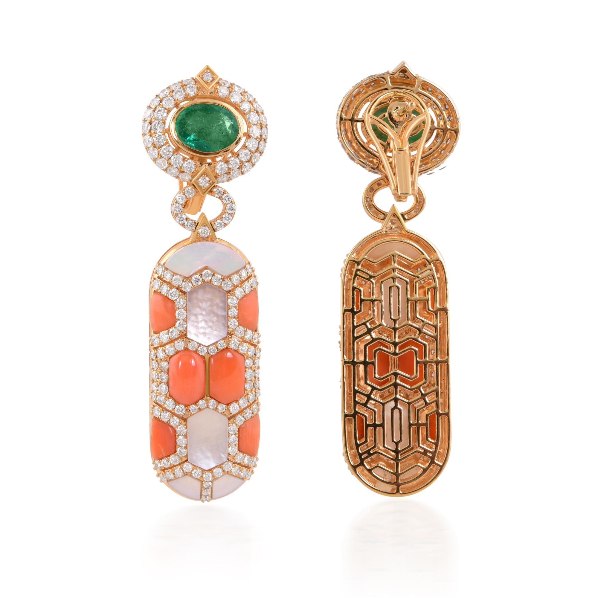 At the heart of each earring, vibrant coral gemstones radiate warmth and vitality, their natural hues reminiscent of the ocean's depths. Complementing the coral are lush emeralds, each possessing a rich green hue that exudes sophistication and