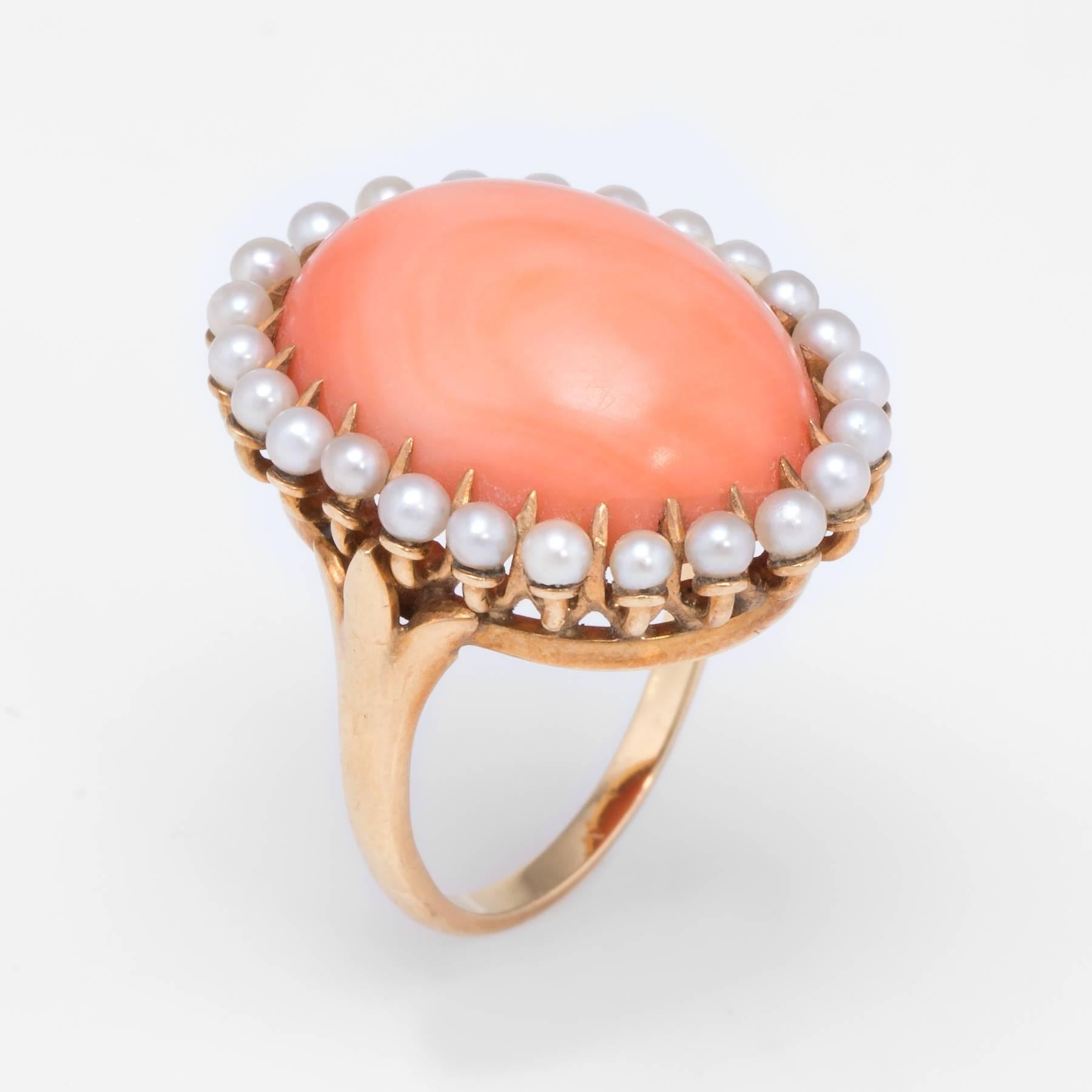 Overview:

Elegant vintage cocktail ring (circa 1940s to 1950s), crafted in 14 karat yellow gold. 

Centrally mounted cabochon cut coral measures 18mm x 13mm (estimated at 8 carats), accented with 1.5mm seed pearls. The coral is in excellent