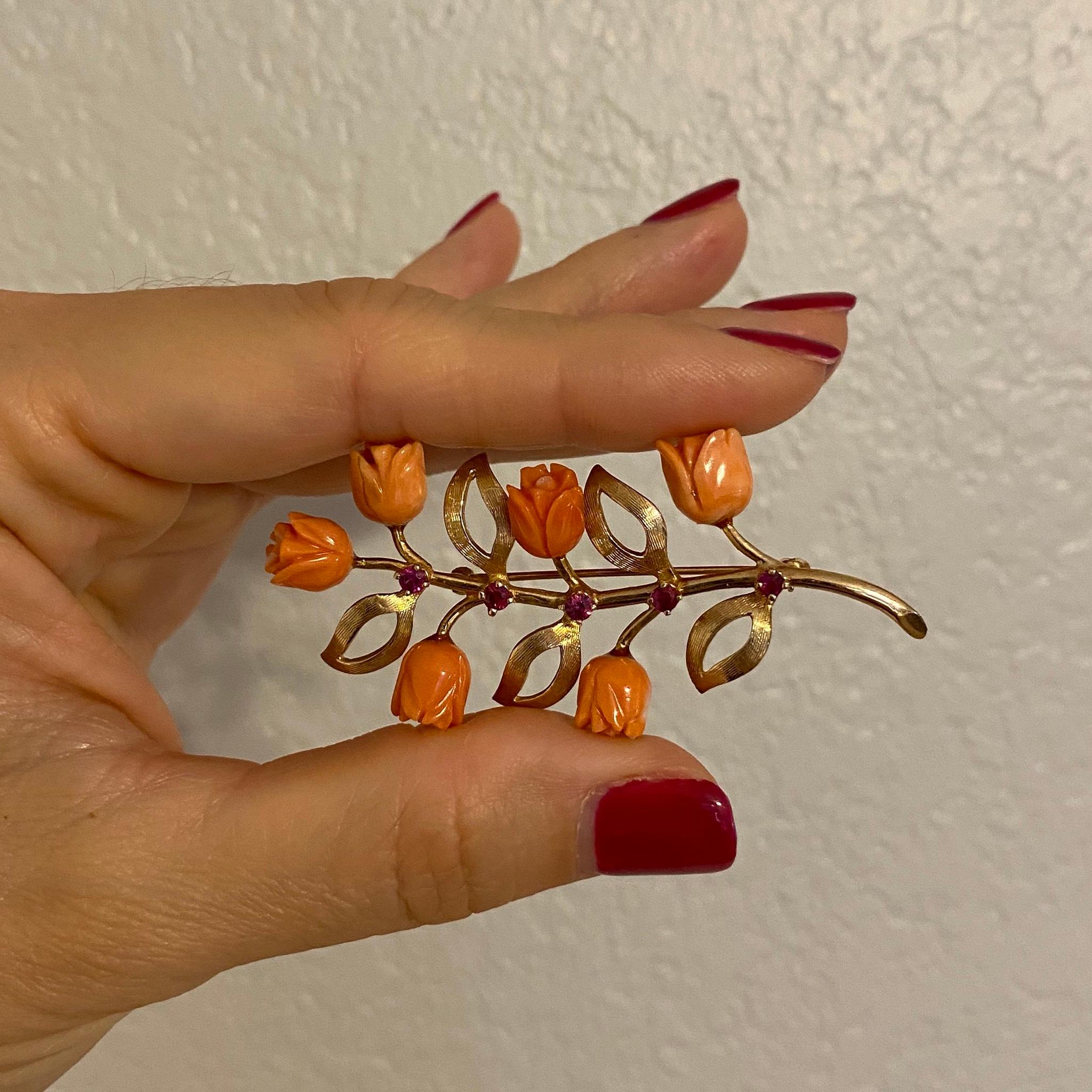 Beautiful Natural Coral and Rubies Branch and Floral brooch, set with 6 natural Coral Roses, weighing 6 total Carat weight and 5 round Rubies weighing 0.33 total carat weight. Hand crafted in 14 Karat rose Gold; Pin measures approx. 2.5” Long. Chic