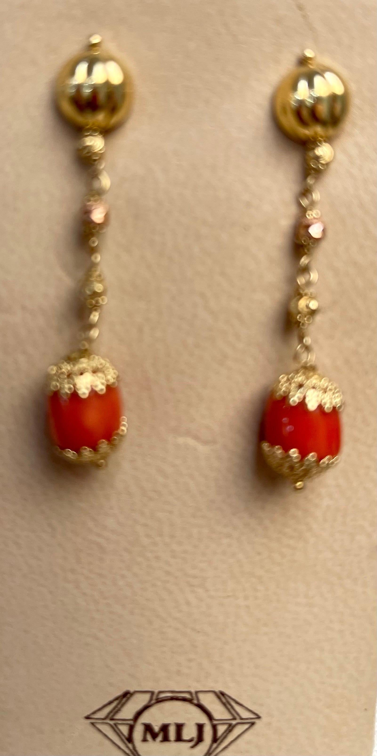 Natural Coral Simple hanging / Dangling Earring in 18 Karat Yellow Gold 
 Coral Natural , Very Red/Tomato color , Very desirable color and quality. Approximately 7MM
perfect pair made in 18 Karat yellow gold. Natural coral of this size are hard to