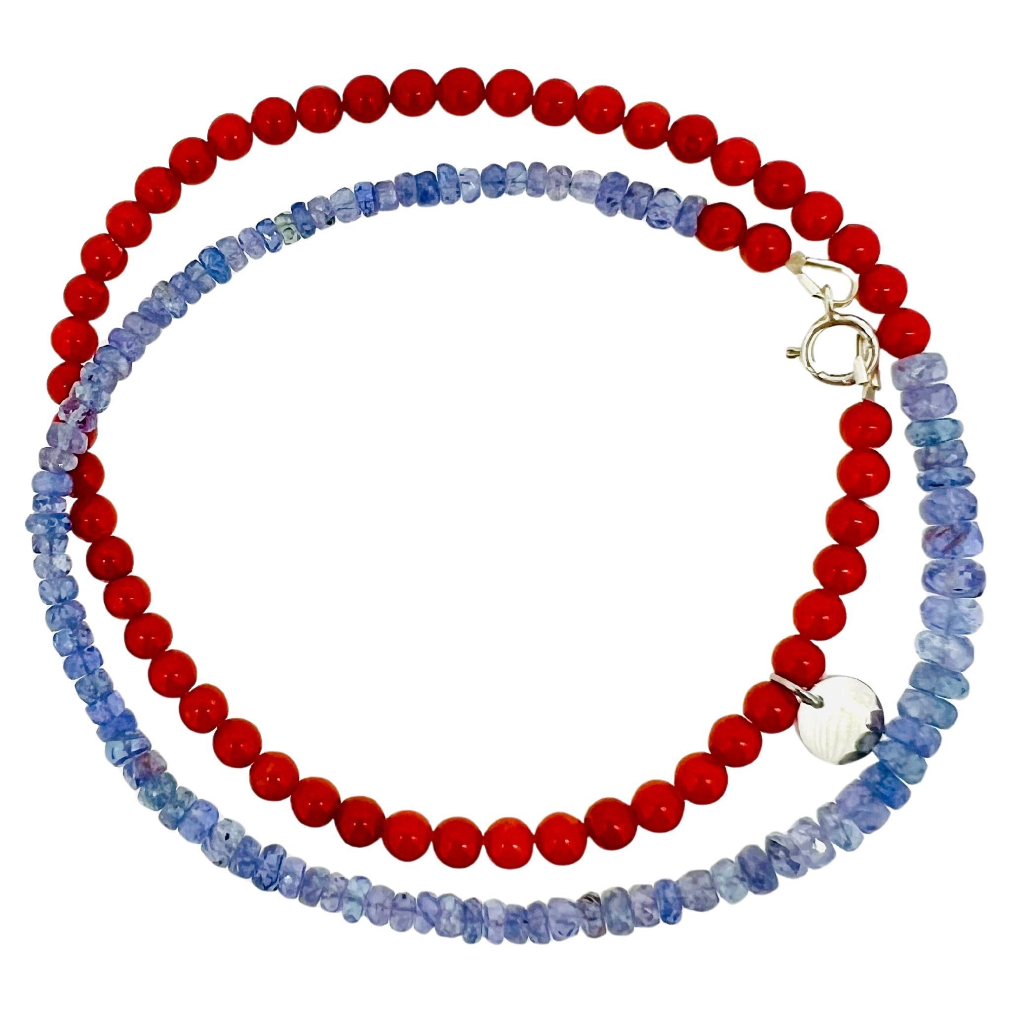 Questa splendida collana artigianale presenta perle di corallo naturale (4 mm di diametro) abbinate a scintillanti perle di tanzanite viola, creando una splendida combinazione di tonalità rosse e viola intenso. Il corallo, proveniente da fonti