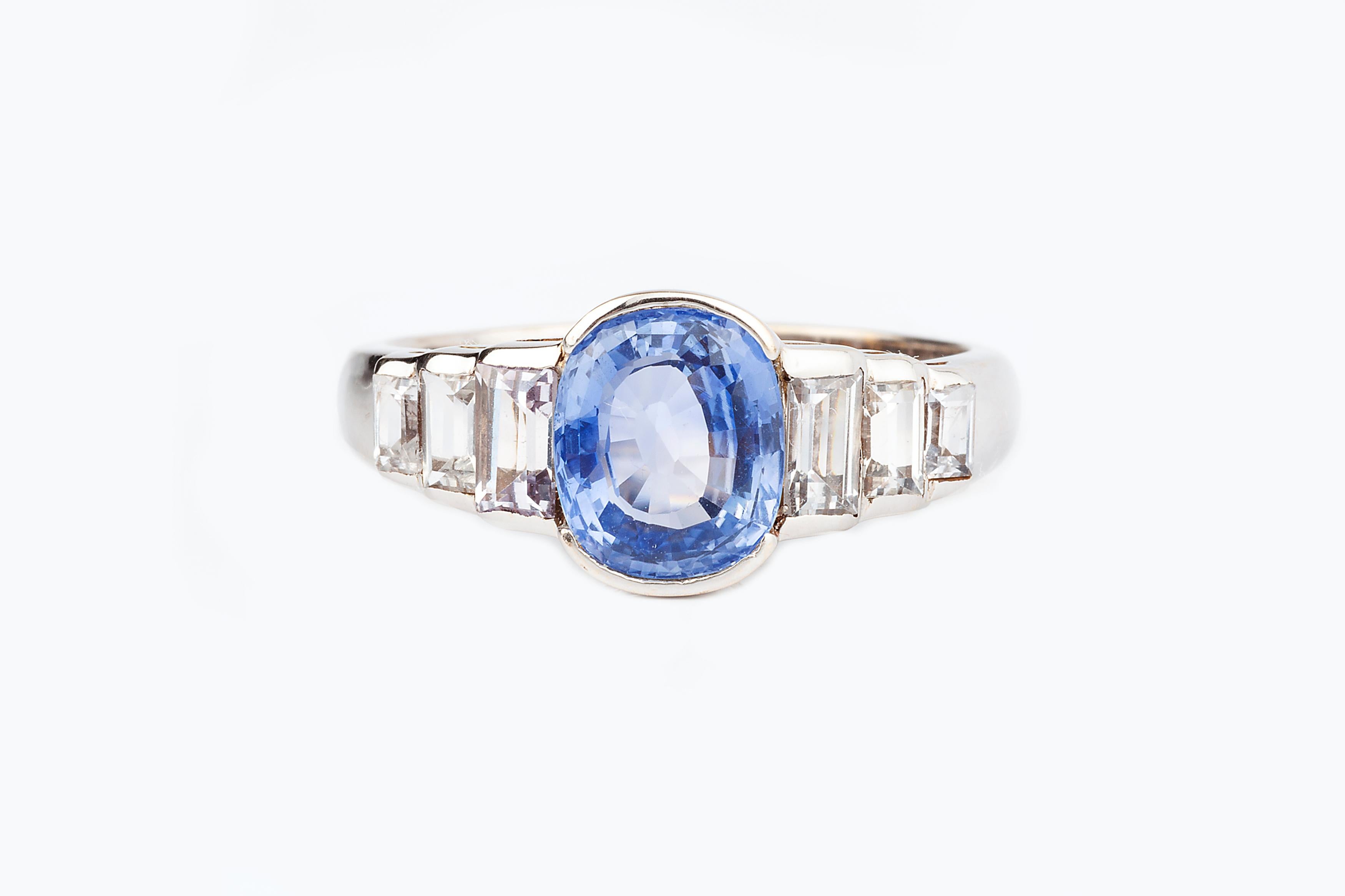 A 2ct natural blue unheated Ceylon sapphire and diamond ring set in 18k gold alongside six step cut diamonds totalling just under 1ct. 