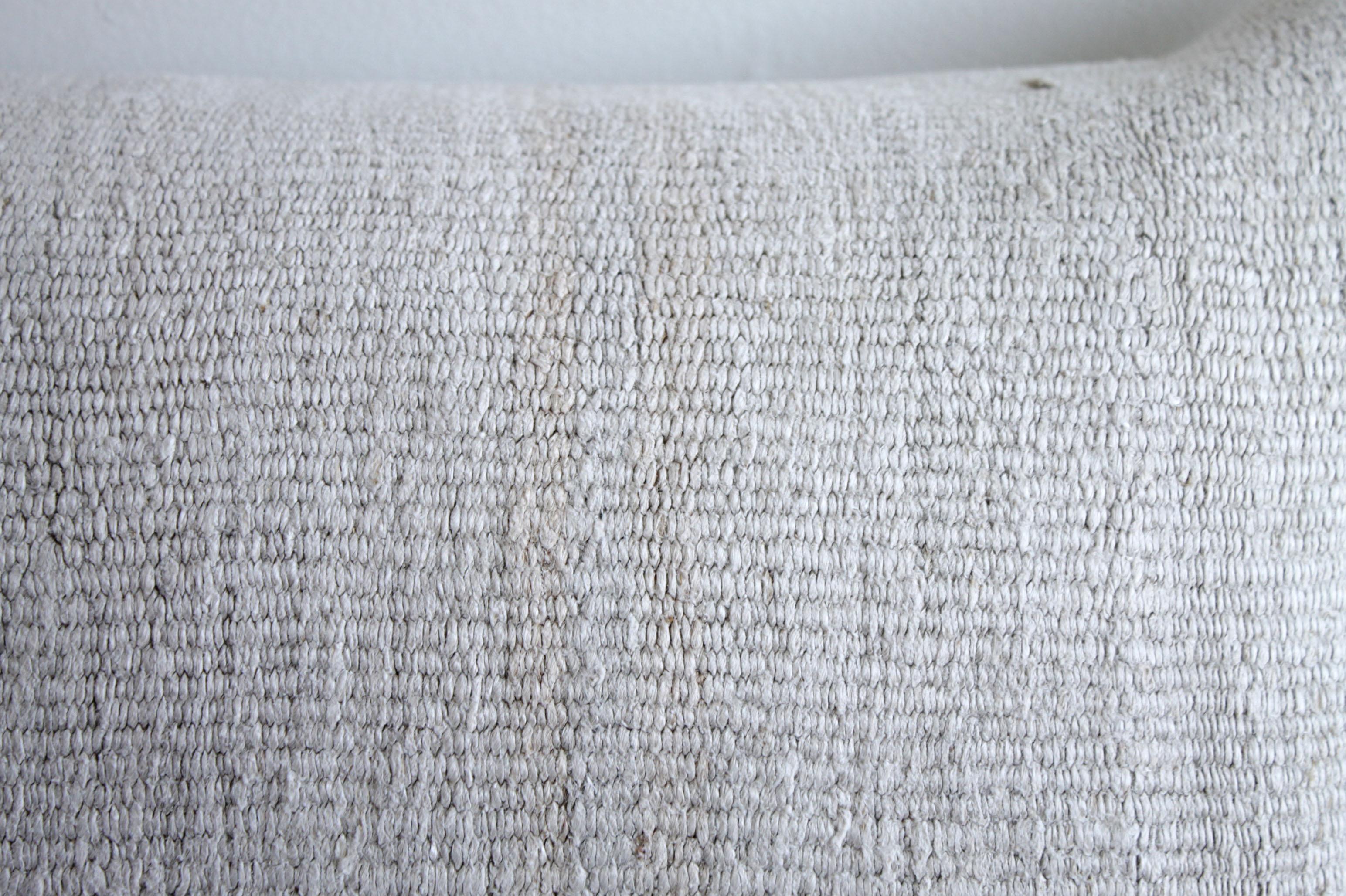 Natural creamy white Turkish hemp rug lumbar pillow
Unique pillow has been made with a Turkish rug, in multiple white tones, and some variations of white woven through. The face is fully lined, with a coordinating backing in a solid fabric, and
