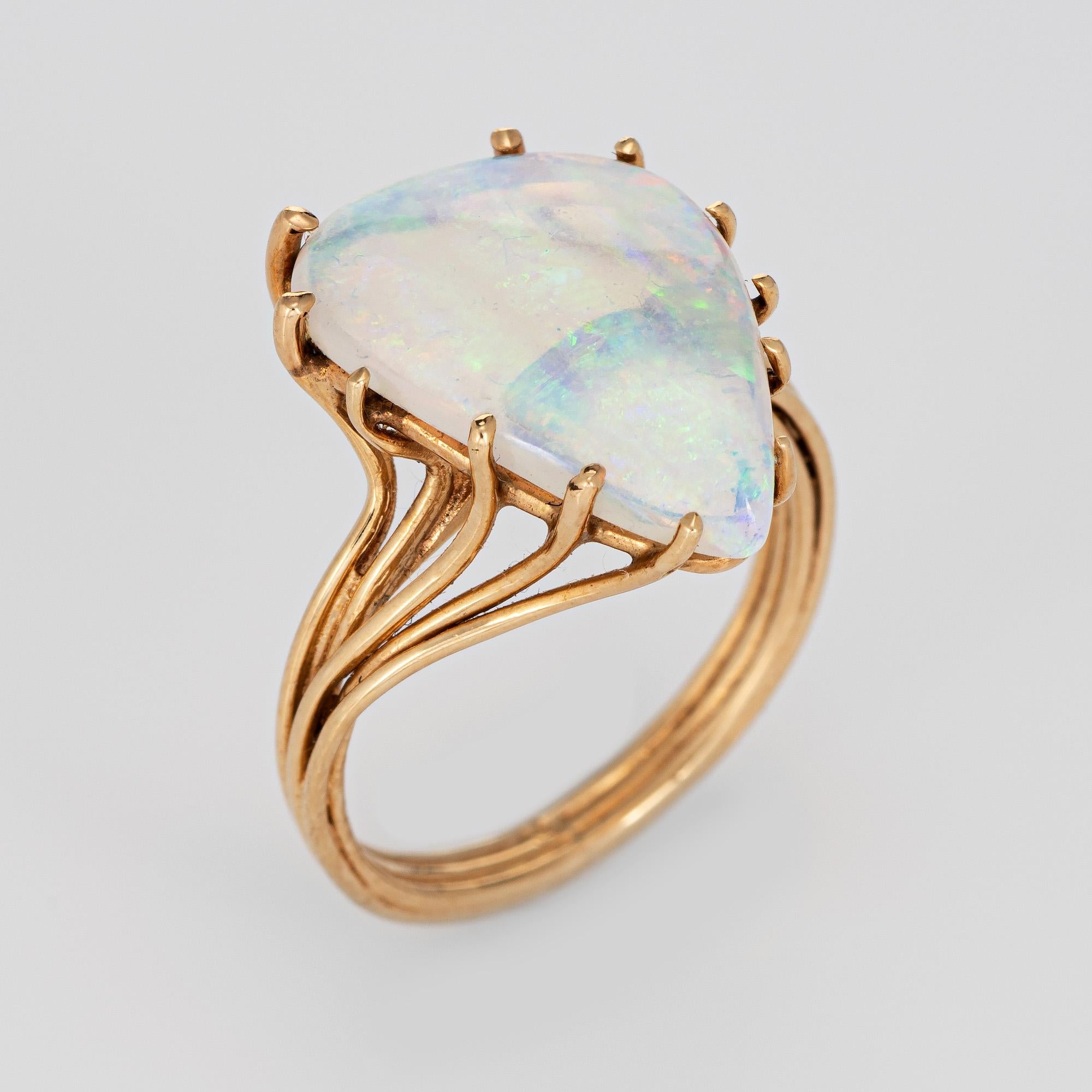 Stylish vintage natural crystal opal ring (circa 1970s to 1980s) crafted in 14 karat yellow gold. 

Natural crystal opal measures 16.5mm x 12mm (estimated at 3.50 carats). The opal is in excellent condition and free of cracks or chips. 

The crystal