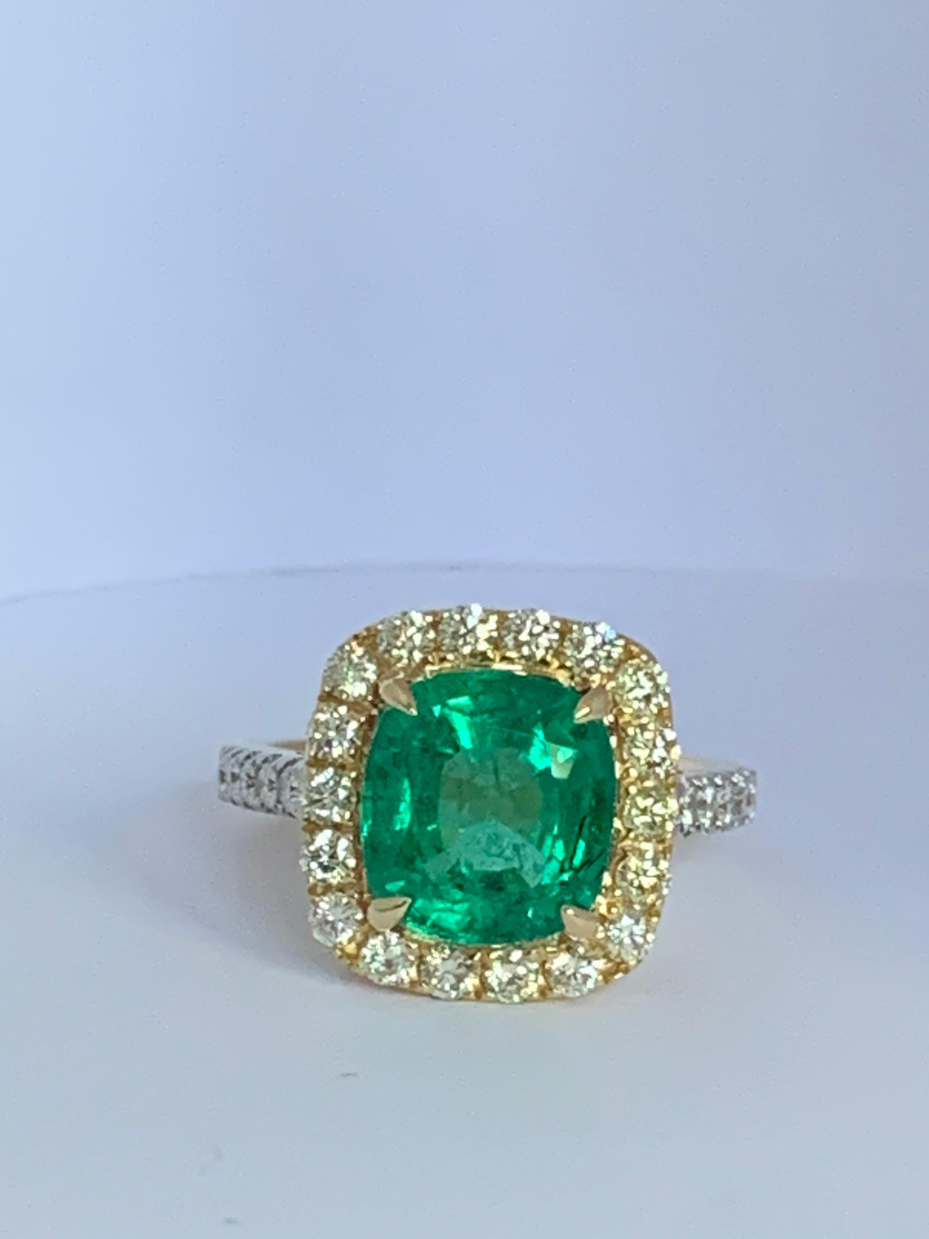 Natural Cushion shape Emerald is 3.80 Carat and Halo of Round yellow diamonds is 0.66 Carat and additional 0.21 Carat white diamond Ring is set in 18Karat Yellow Gold, The Ring is size 7 and can be resized if needed.