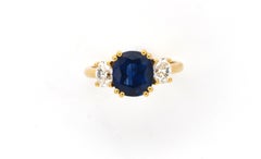 Natural cushion Sapphire and oval diamond three stone ring