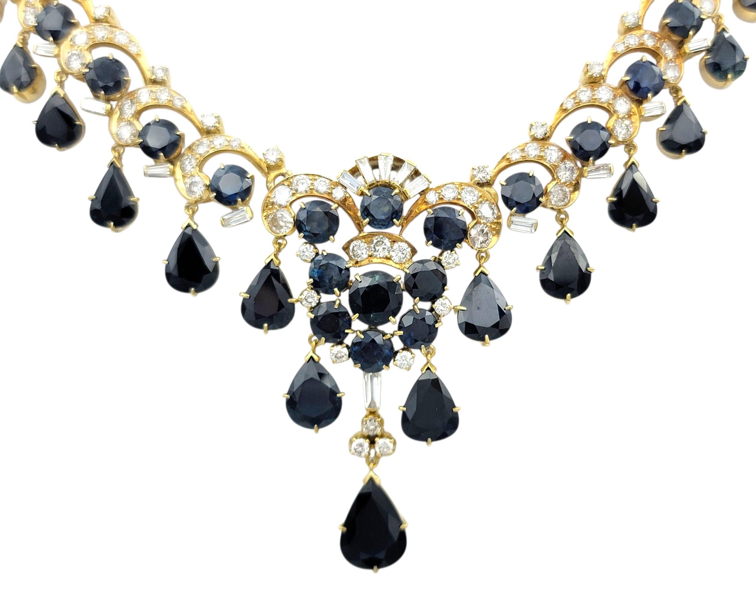 Ce collier opulent attire l'attention avec un ensemble royal de riches saphirs bleus et de diamants rayonnants sertis dans de l'or jaune 18 carats lumineux. La pièce maîtresse est constituée d'un grand saphir en forme de poire qui sert de point
