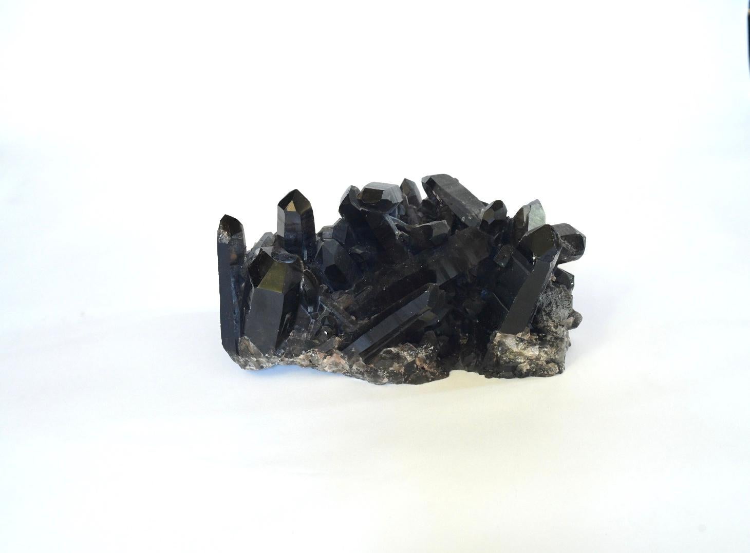 Nature dark rock crystal cluster with polish brass stand.
The sculpture without stand. Measures: 11” /L x 6” /W x 5” /H.