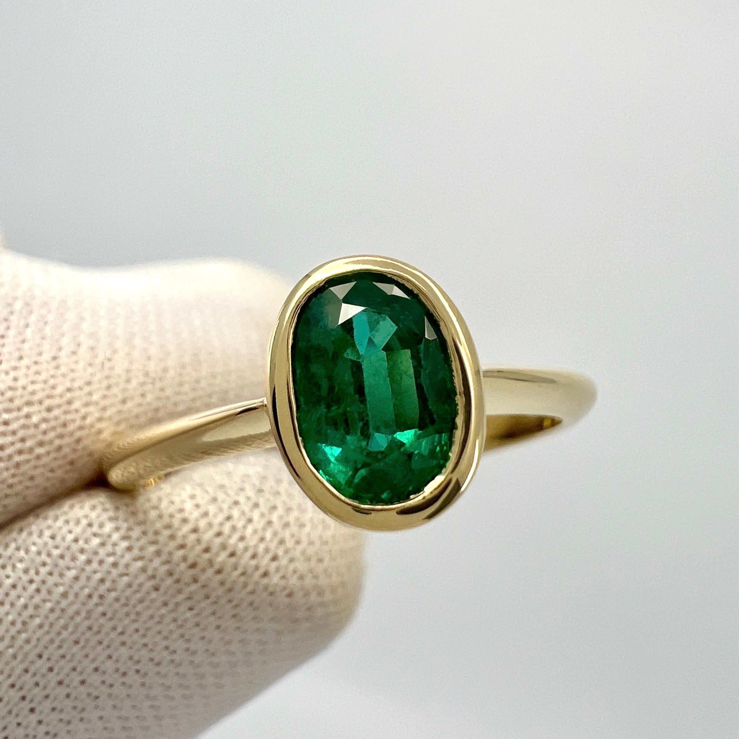 Fine Deep Green Oval Cut Natural Emerald 18k Yellow Solitaire Bezel Rubover Ring.

0.85 Carat emerald with a stunning deep green colour and very good clarity. Some small natural inclusions visible when looking closely, as to be expected with natural