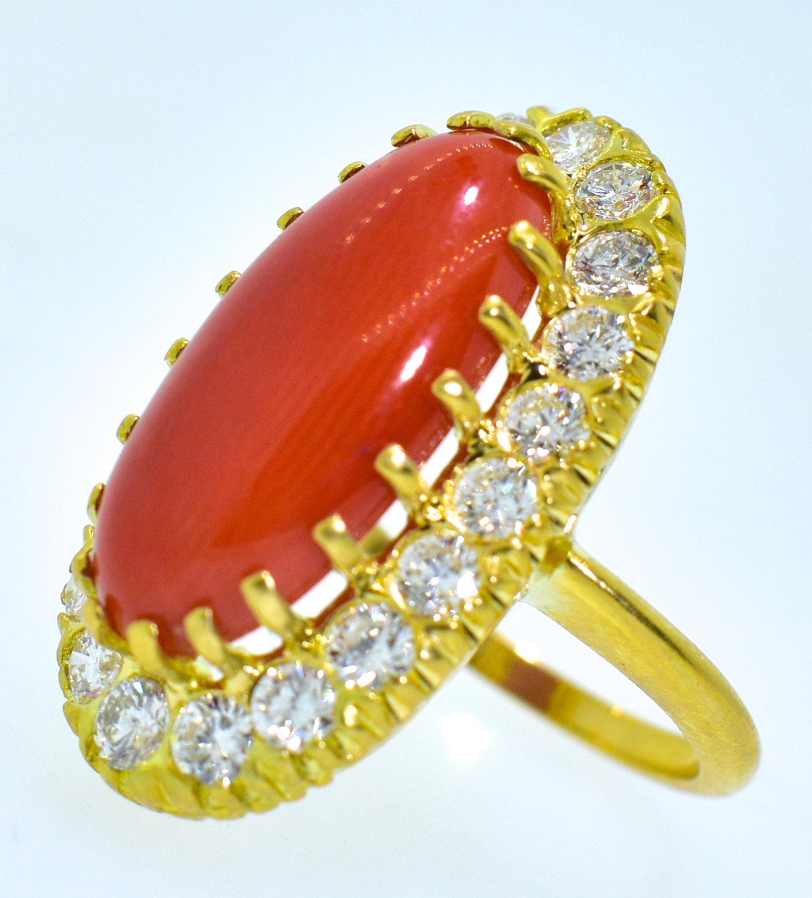 Natural red coral from the Mediterranean is surrounded with fine white brilliant cut diamonds all hand set in 18K.  The coral weighs approximately 6 cts and is surrounded by 1.85 cts of fine white brilliant cut diamonds.  These diamonds are all well