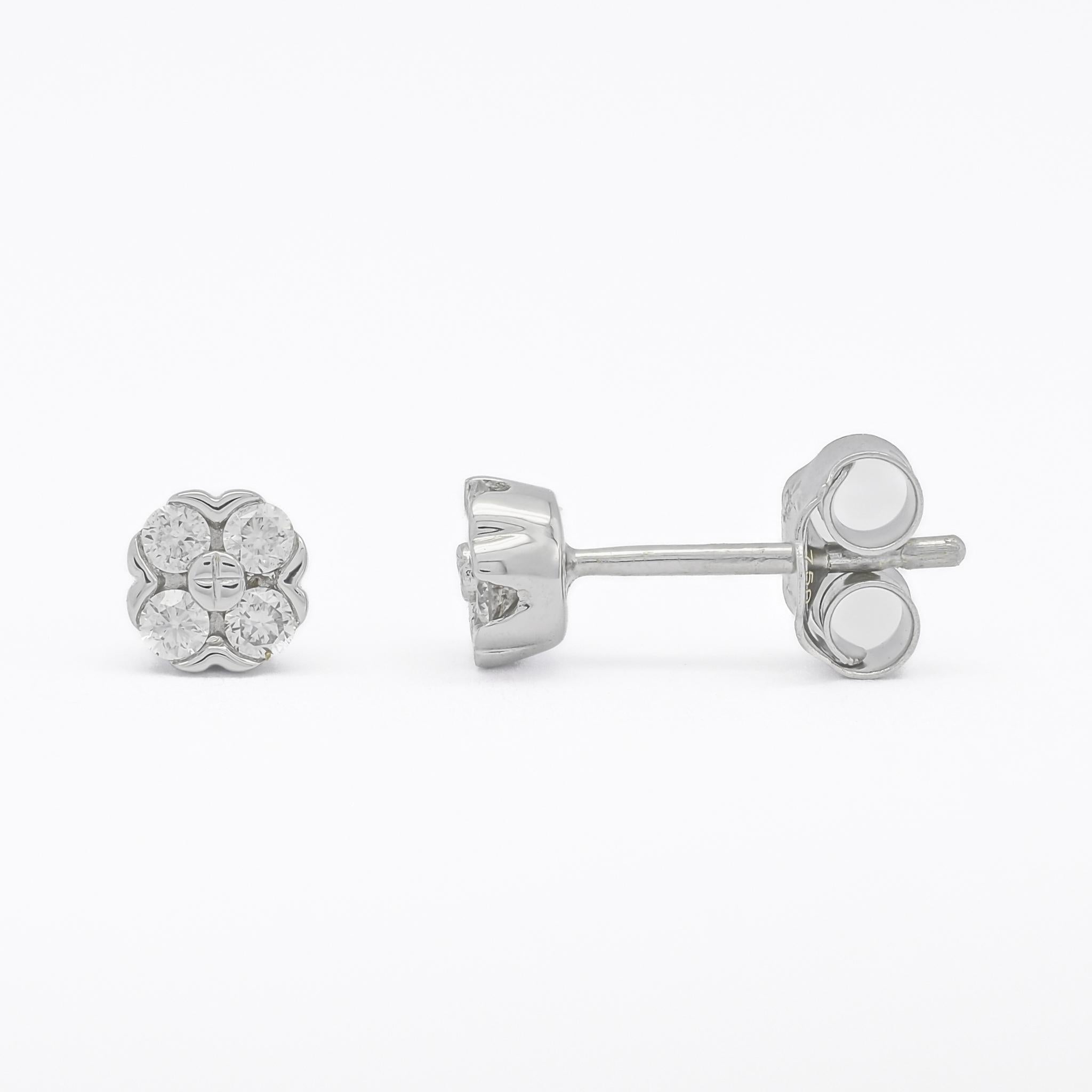 Crafted with meticulous attention to detail, each earring features a mesmerizing arrangement of glistening diamonds set in a bezel flower setting, radiating timeless charm and grace.

The simplicity of the flower shape design adds a touch of whimsy