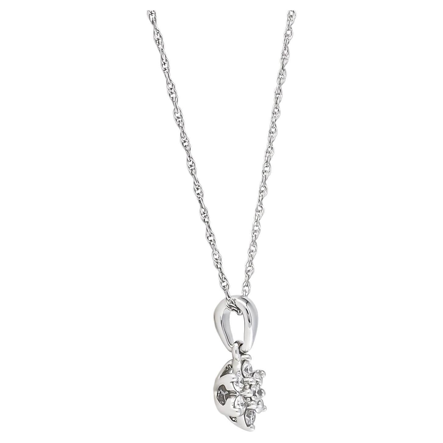 Indulge her in the luxury of understated elegance with our exquisite flower-shaped pendant necklace. Delicately crafted from 18KT White Gold, this piece is adorned with round-shape diamonds, meticulously set in a Cluster-style arrangement, suspended