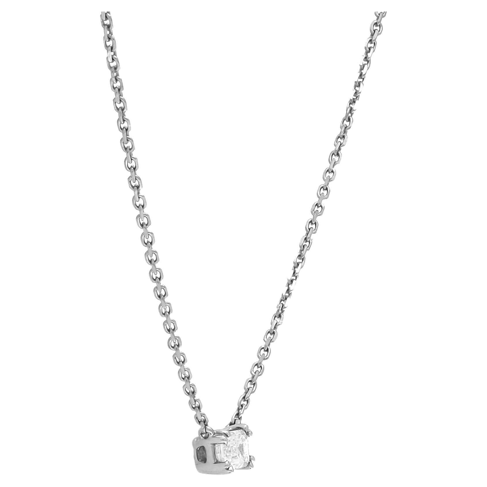 This exquisite piece of jewelry is a testament to the timeless allure of simplicity and elegance. Suspended from an 18-karat yellow gold chain, the focal point of this necklace is a mesmerizing emerald-cut natural diamond weighing 0.13 carats. The