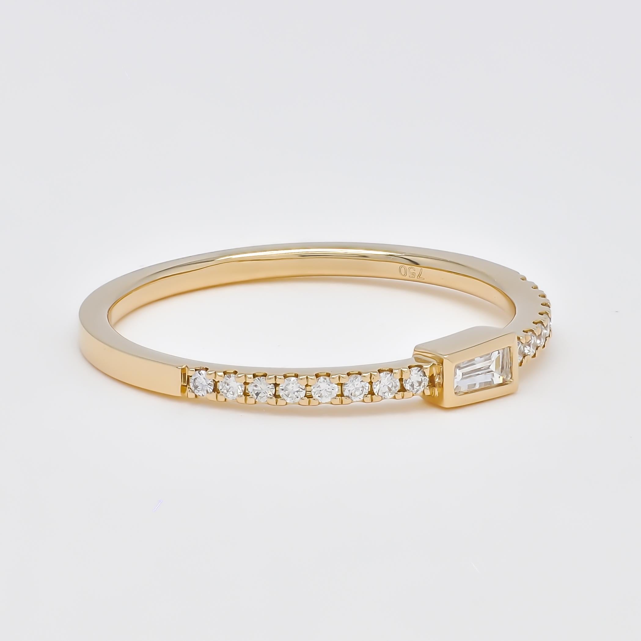  Elevate your style with the remarkable elegance of this exquisite stackable ring, which artfully combines round-shape and baguette diamonds into a singular, striking design. This ring is a sophisticated reimagining of the traditional diamond band,