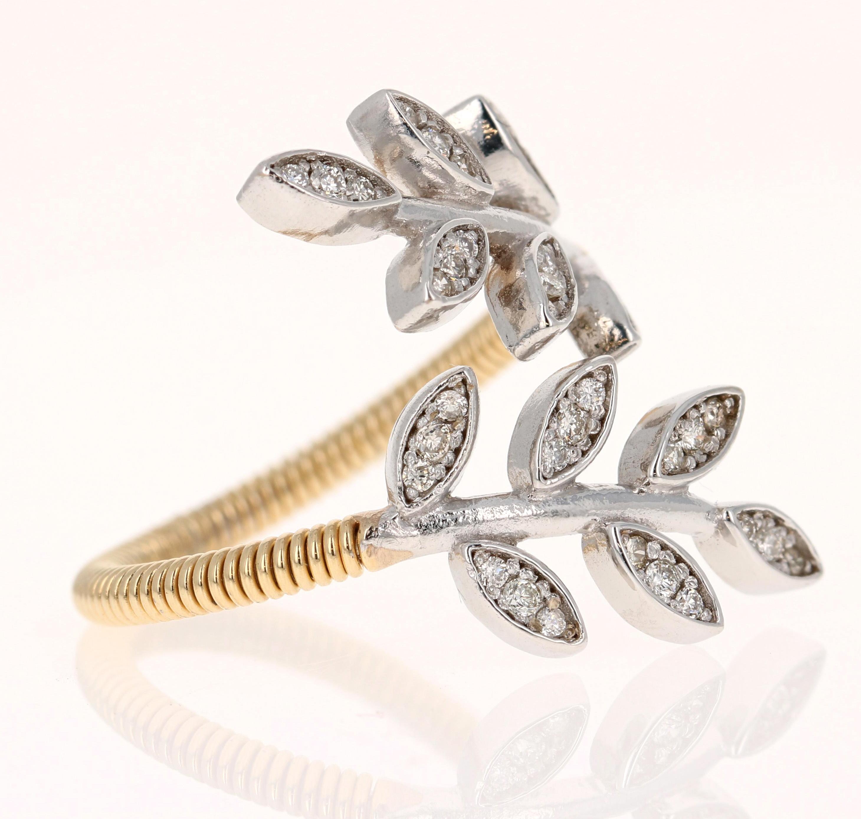 This unique ring has 0.28 carats of Natural Diamonds and has a delicate yellow gold wired shank with two white gold leaves wrapping around to the front. This ring can be worn as an everyday statement ring or even on special occasions. 

The dual