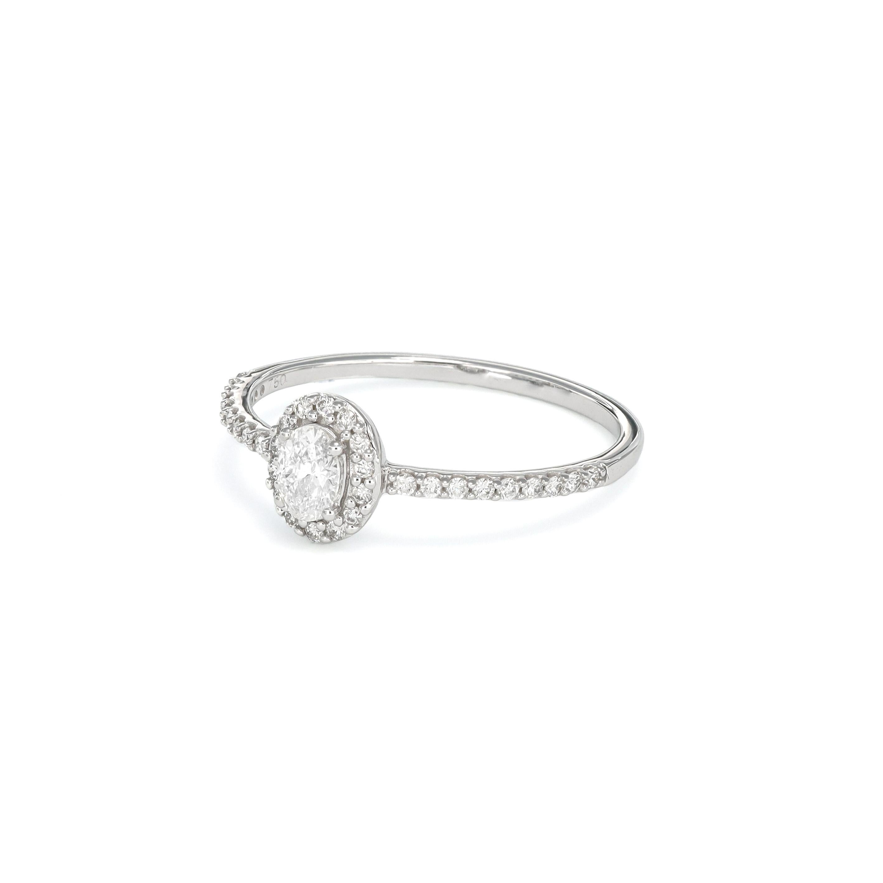 Introducing the epitome of timeless sophistication, behold the exquisite solitaire engagement ring featuring a mesmerizing middle oval-shaped diamond with a halo, elegantly accented by 0.35 carats of diamonds gracefully adorning the shanks. This