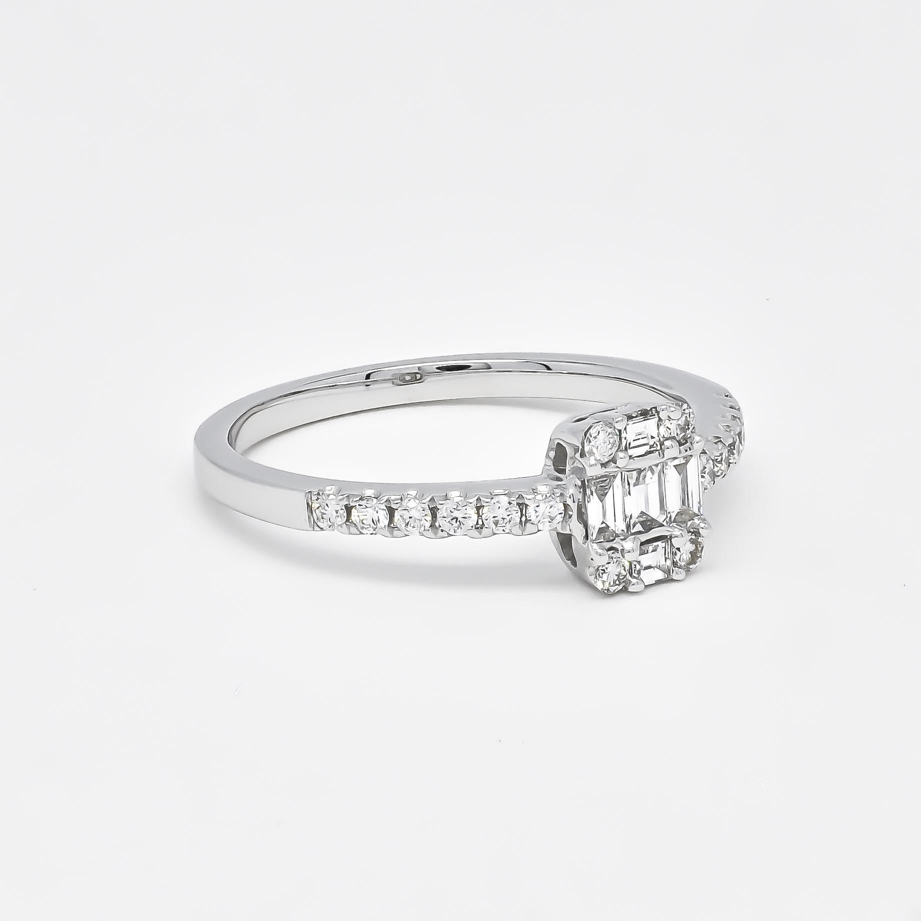 Introducing an exquisite engagement ring that epitomizes elegance and sophistication. Crafted in 18KT white gold, this beautiful ring features a captivating cluster of diamonds at its center. The intricate design includes both round and baguette-cut