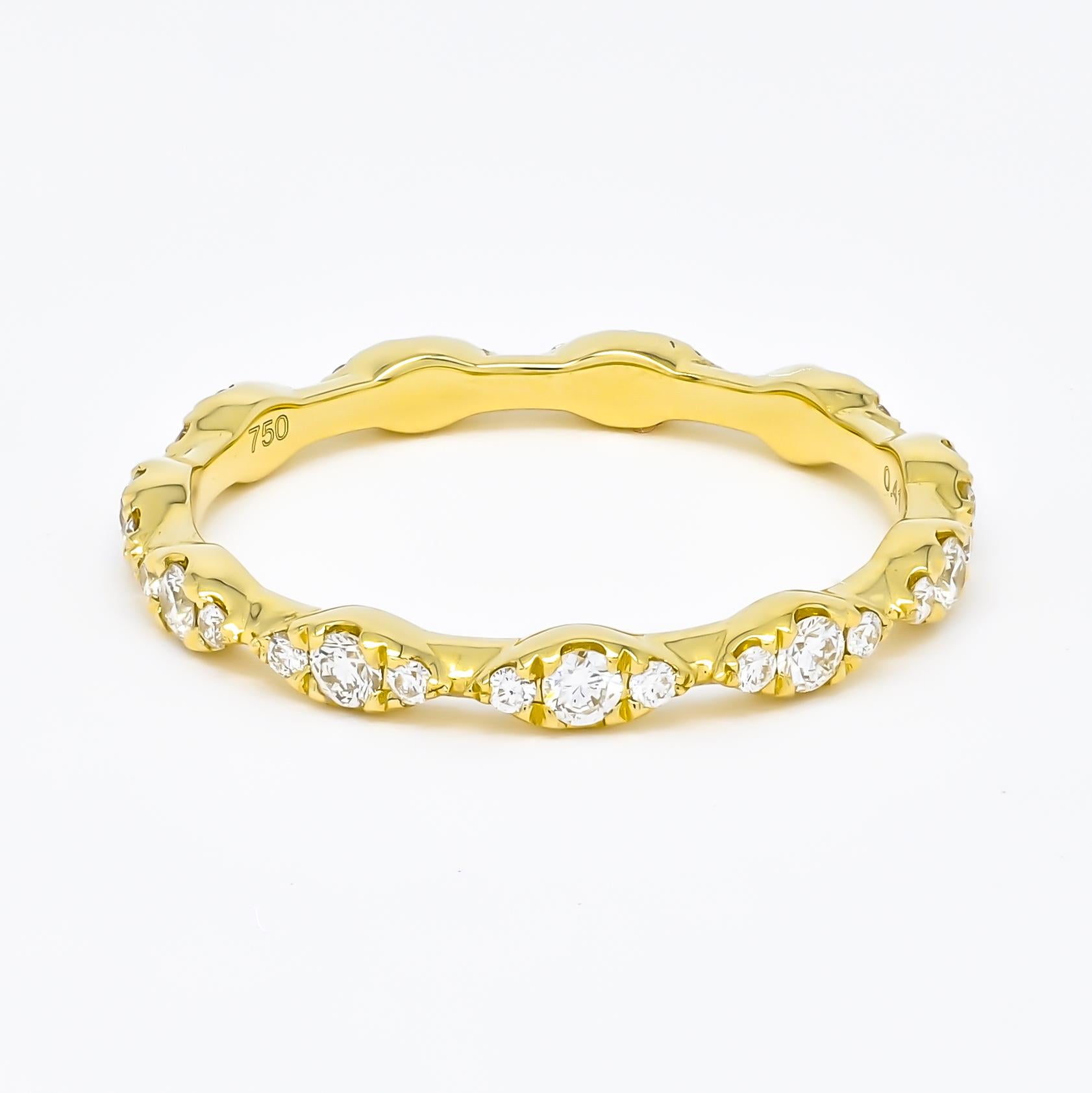 At the center of this delicate setting sits a large, round diamond, beautifully accented by two smaller diamonds on each side.

Together, they total 0.41 carats, each stone meticulously chosen for its brilliant sparkle and clarity. The unique flow