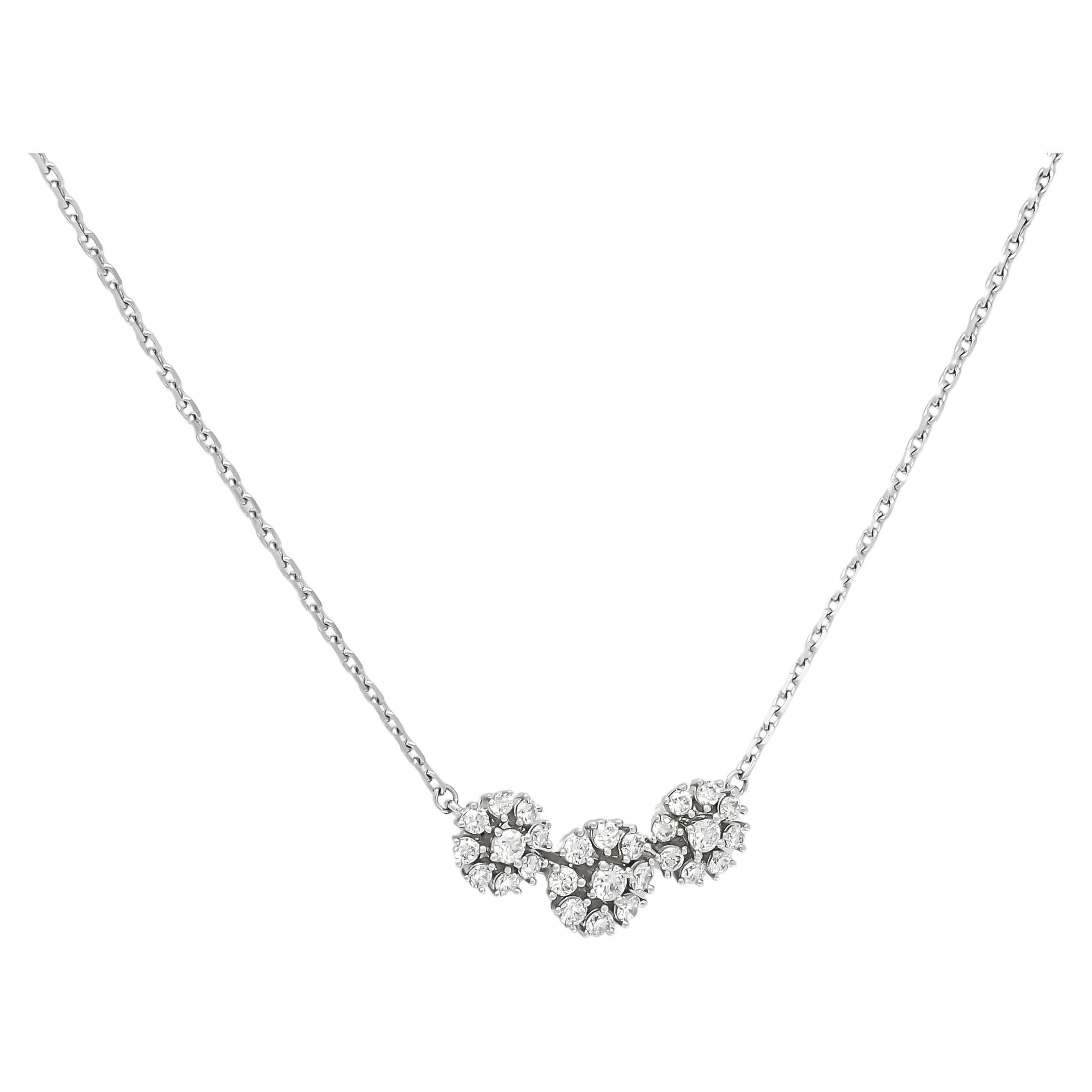 Embrace the enchanting elegance of this pendant, crafted in 18KT white gold and adorned with three dazzling clusters of natural diamonds. Carefully arranged to create a mesmerizing focal point, these clusters radiate sophistication and grace.

Each